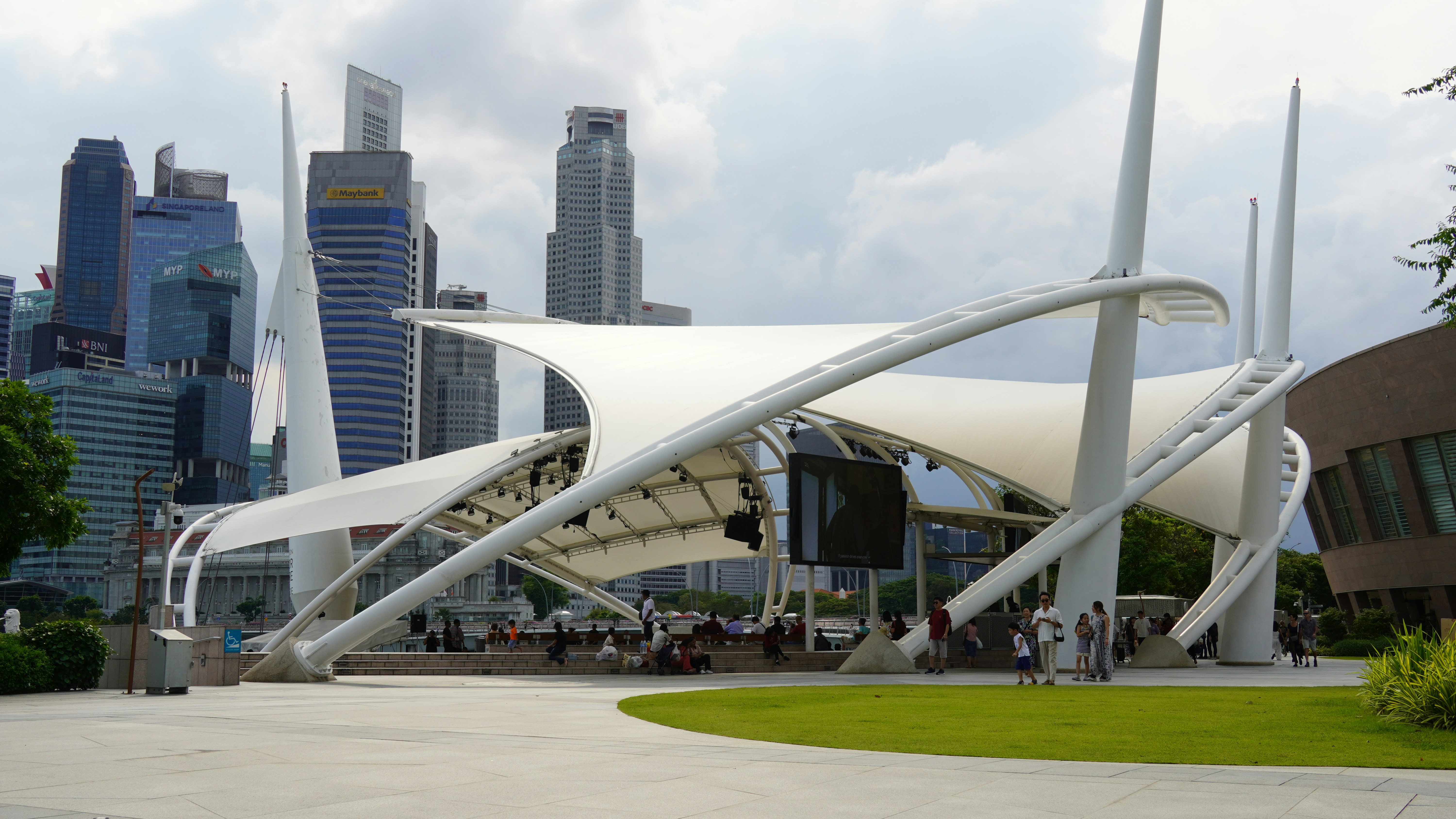 Modern outdoor pavilion with city skyline in background