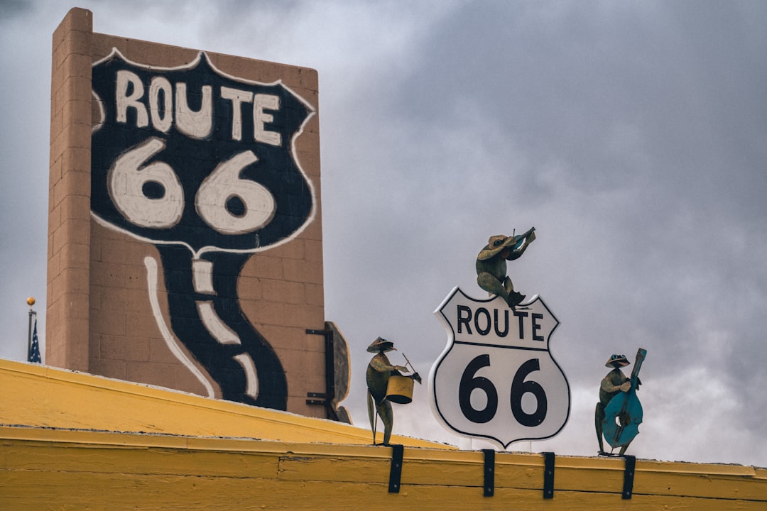 Route 66 sign with quirky figures on rooftop