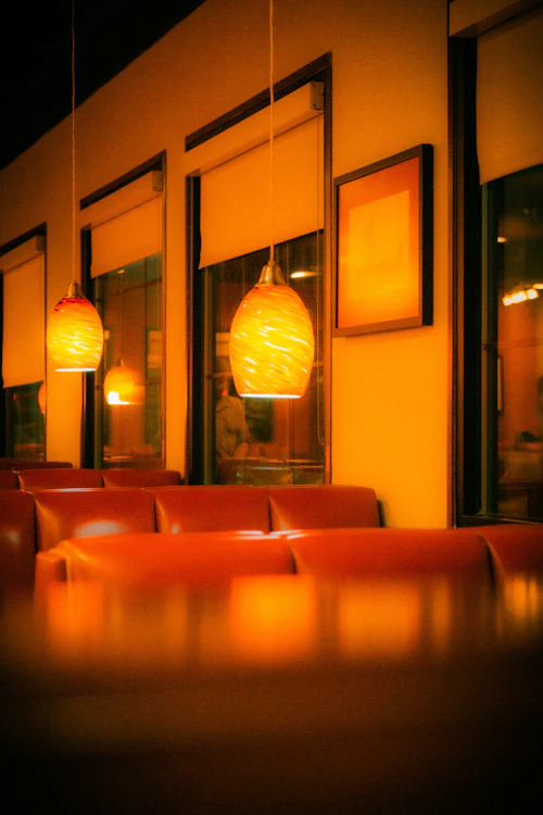 Warm, cozy restaurant booth seating with amber lighting