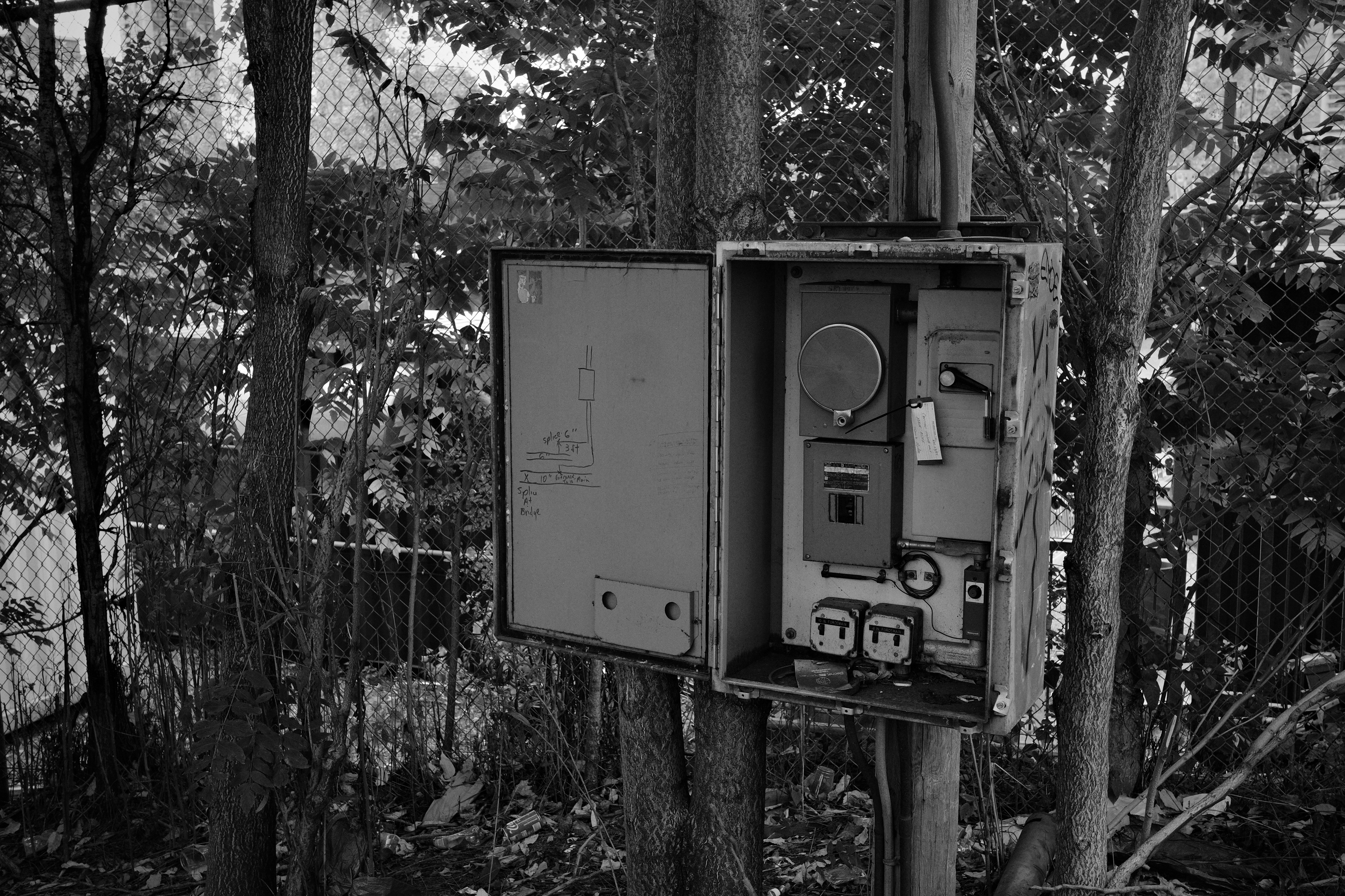 Open electrical box mounted on a pole outdoors