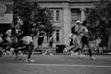 Runners race down a city street