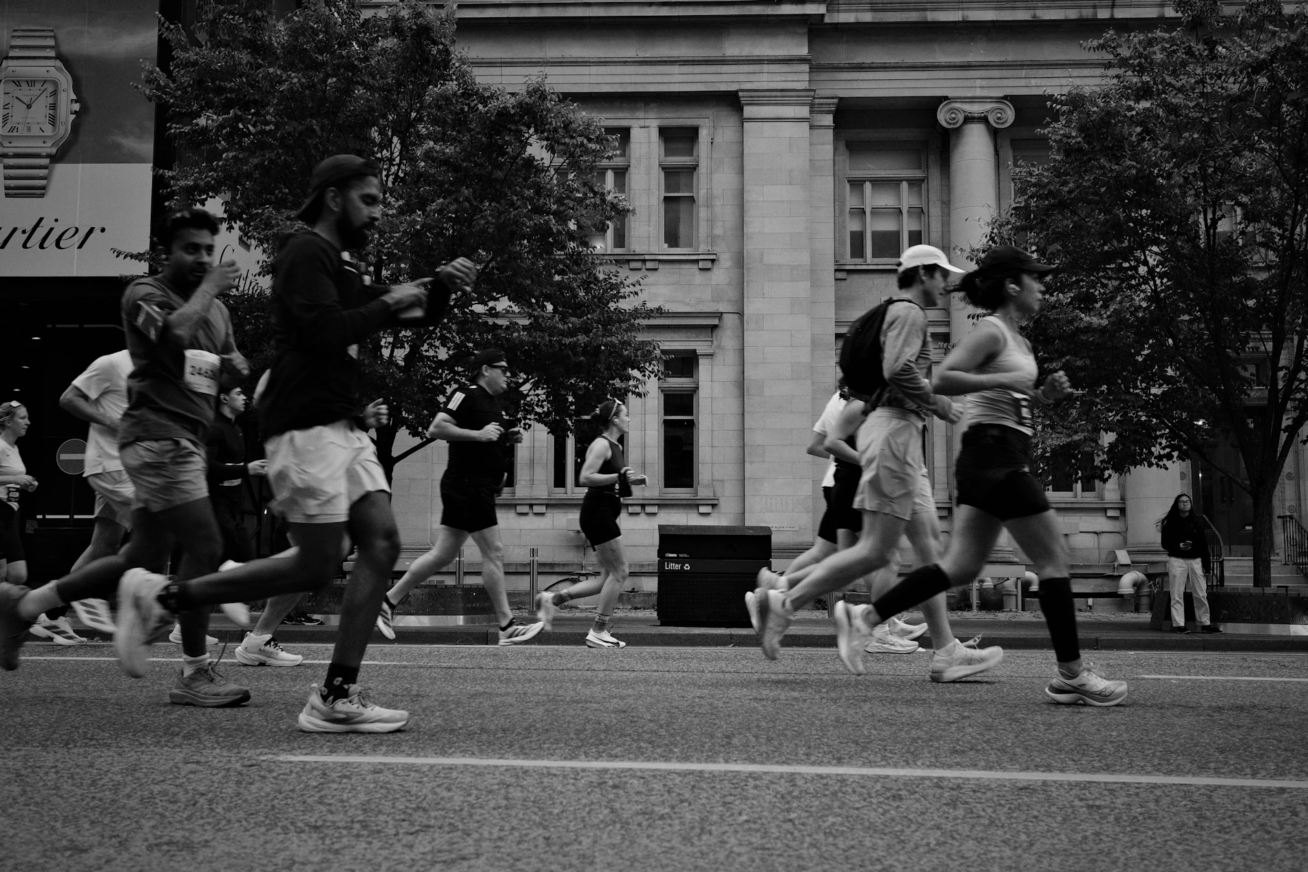 Runners racing together down a city street