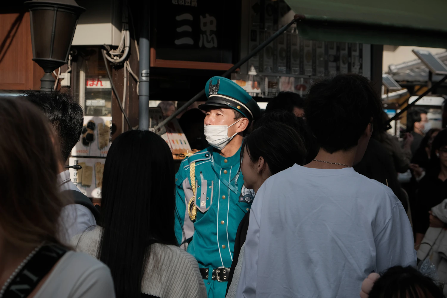 Uniformed security officer observing a crowd at a public event