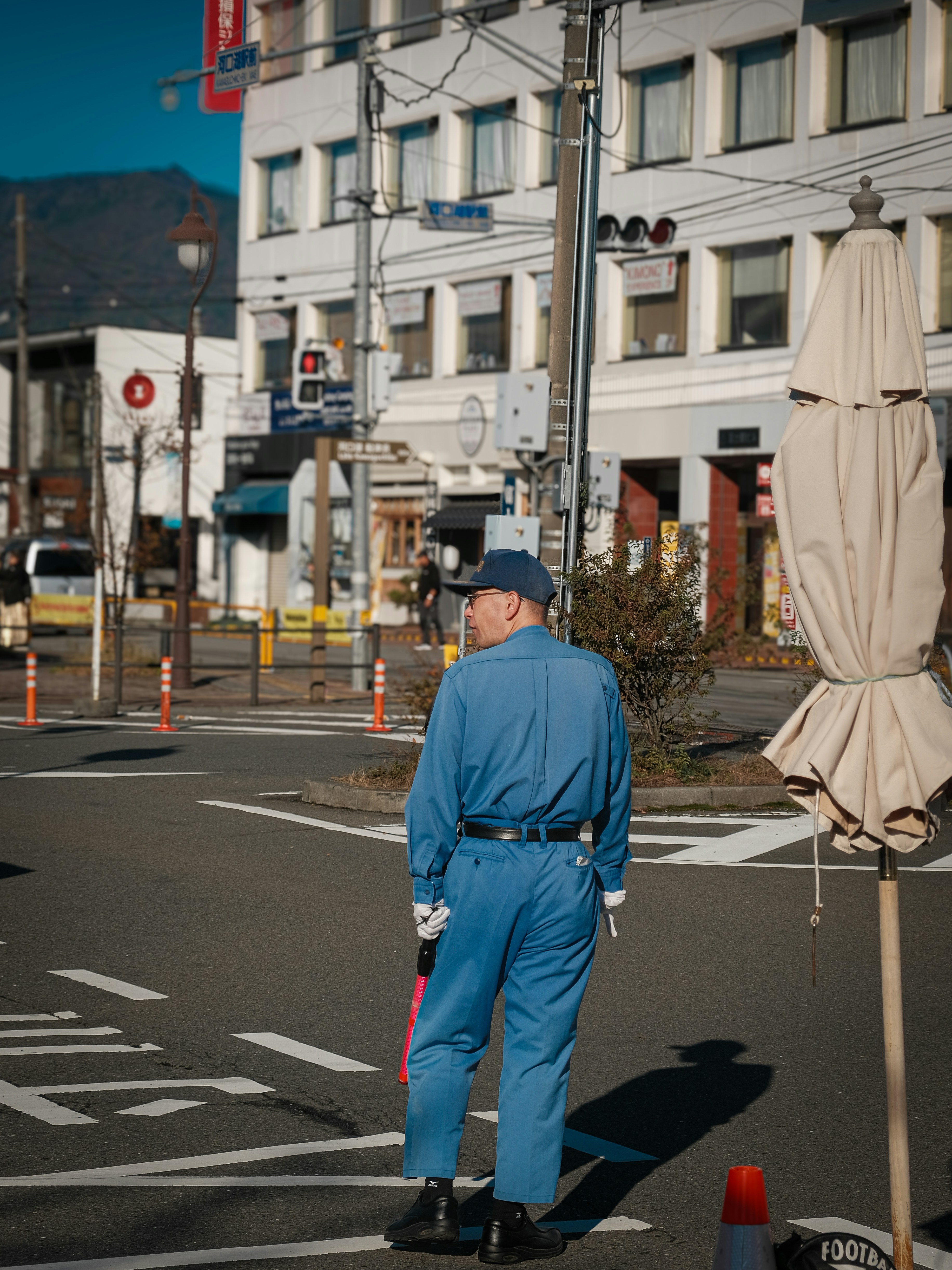 Man in blue uniform directing traffic at intersection