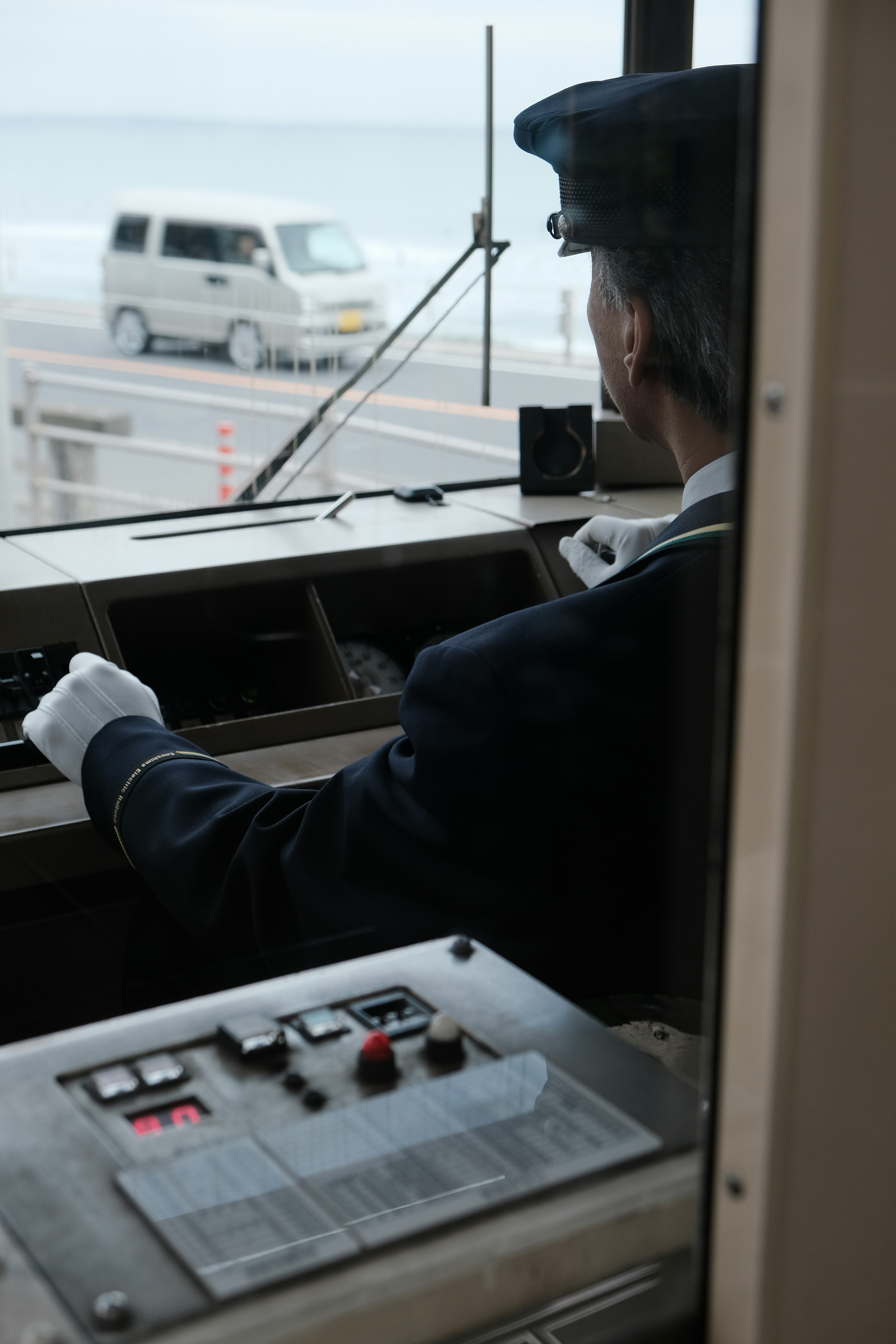 Train conductor in uniform driving a train