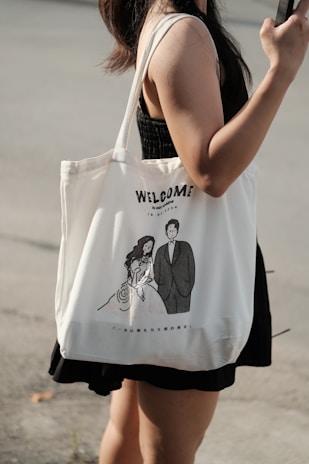 Woman holding a tote bag with wedding illustration