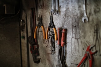 Assorted tools hanging on a workshop wall.