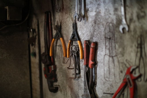 Assorted tools hanging on a workshop wall.