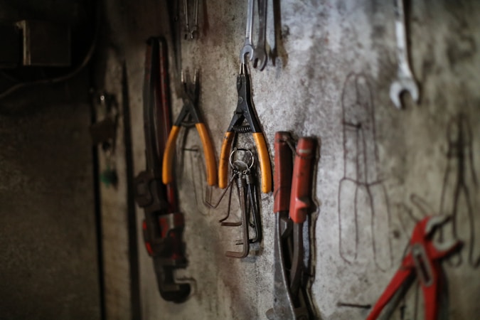 Assorted tools organized on a workshop wall