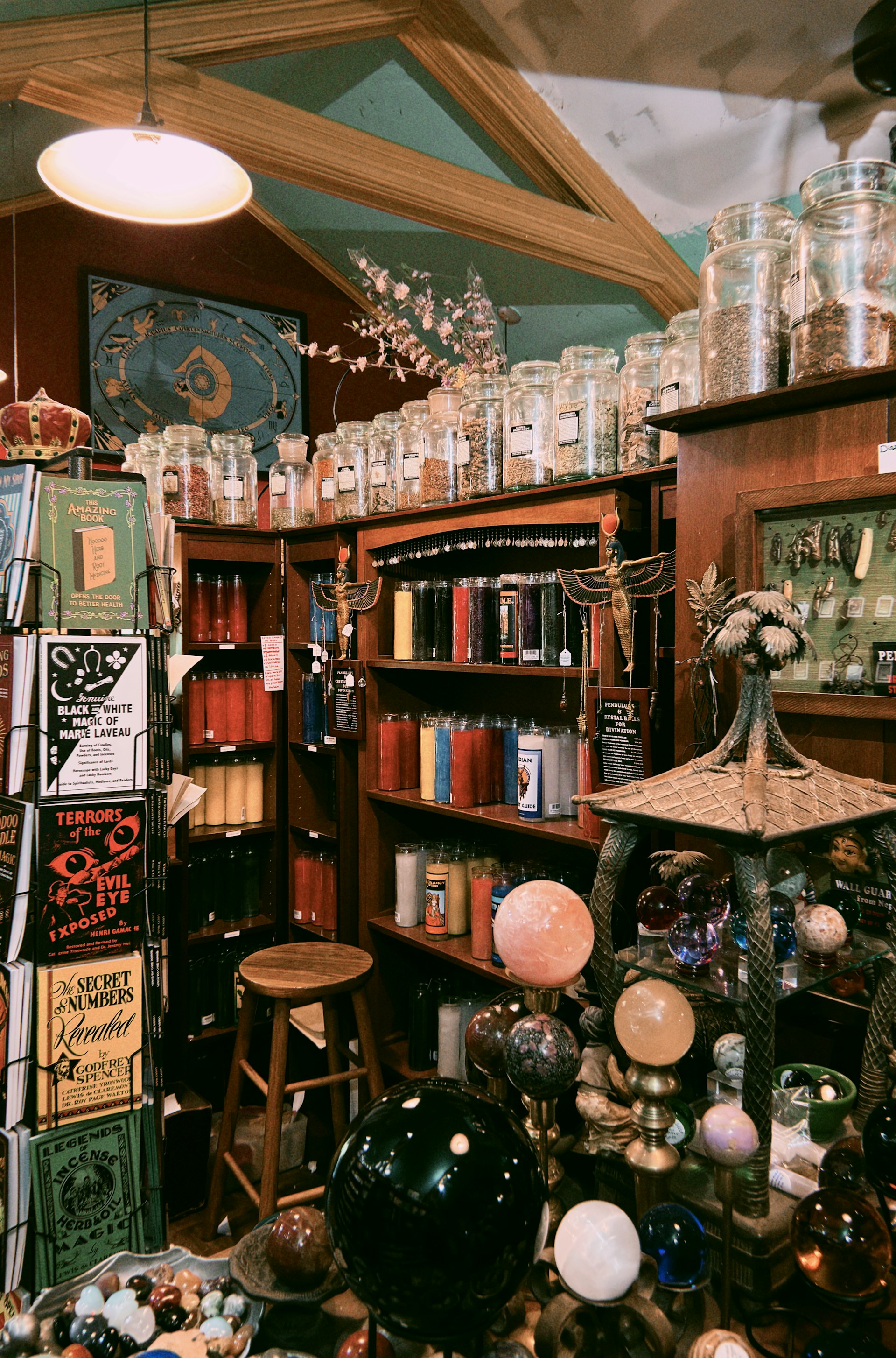 A mystical shop filled with jars, candles, and orbs.