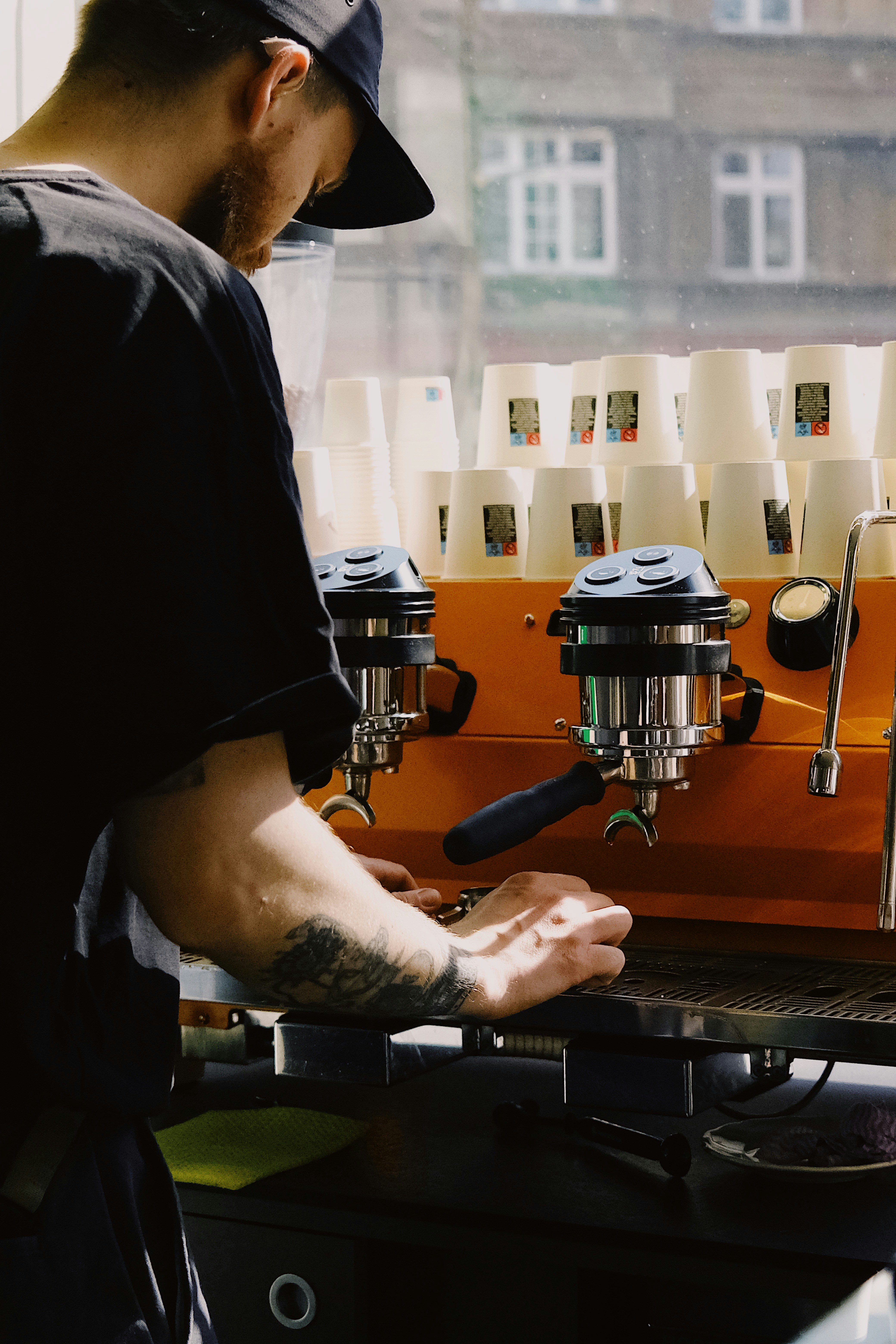 Barista making coffee with an espresso machine.
