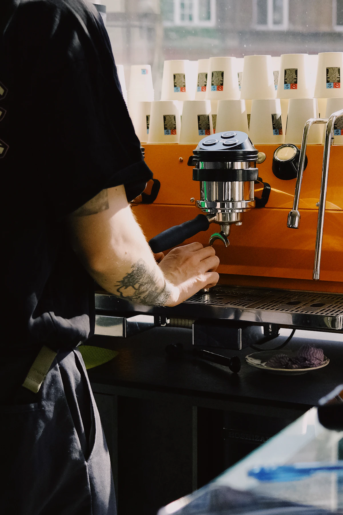 Barista preparing a drink with a commercial espresso machine