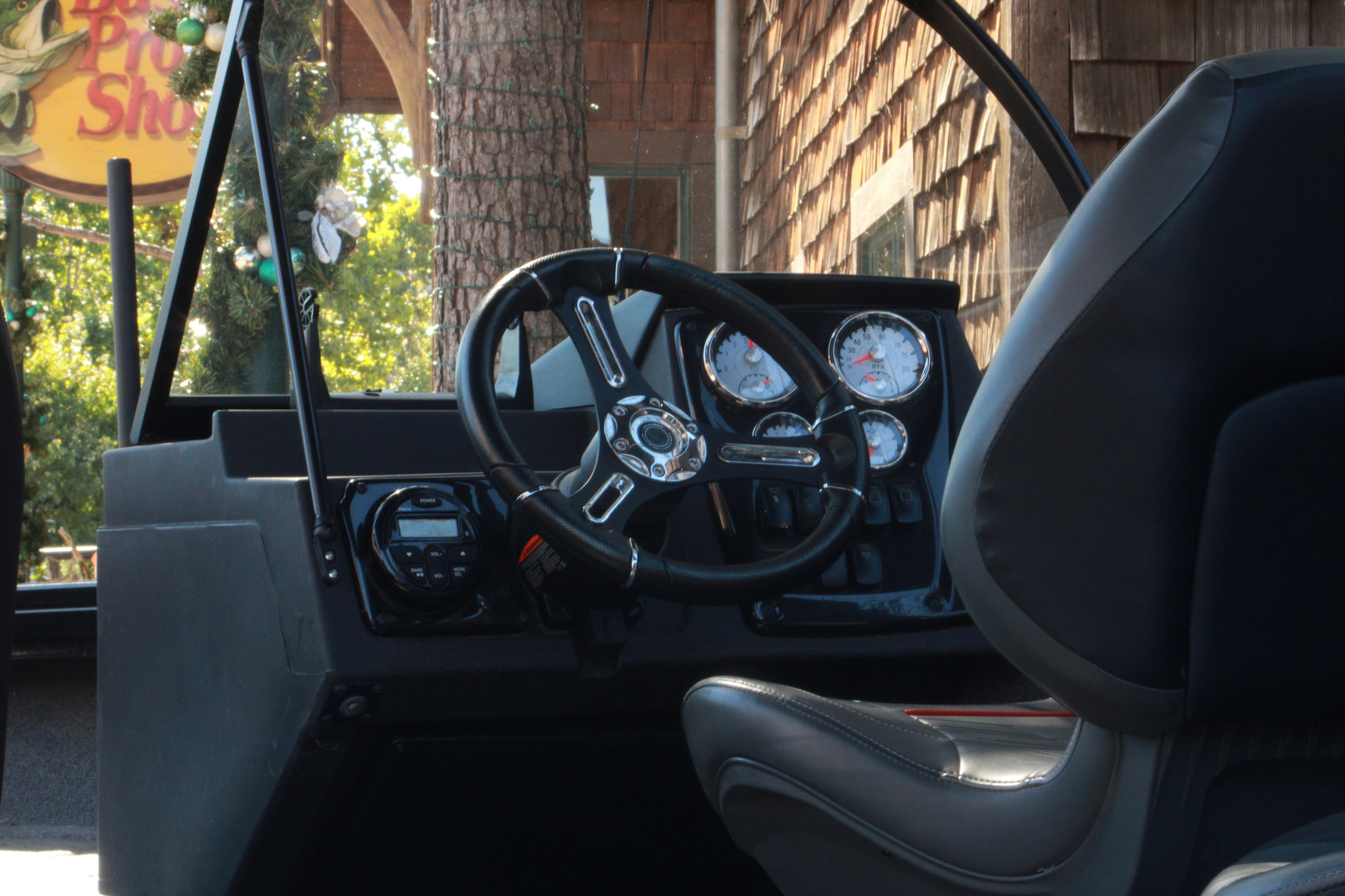 Boat helm and dashboard with gauges and steering wheel