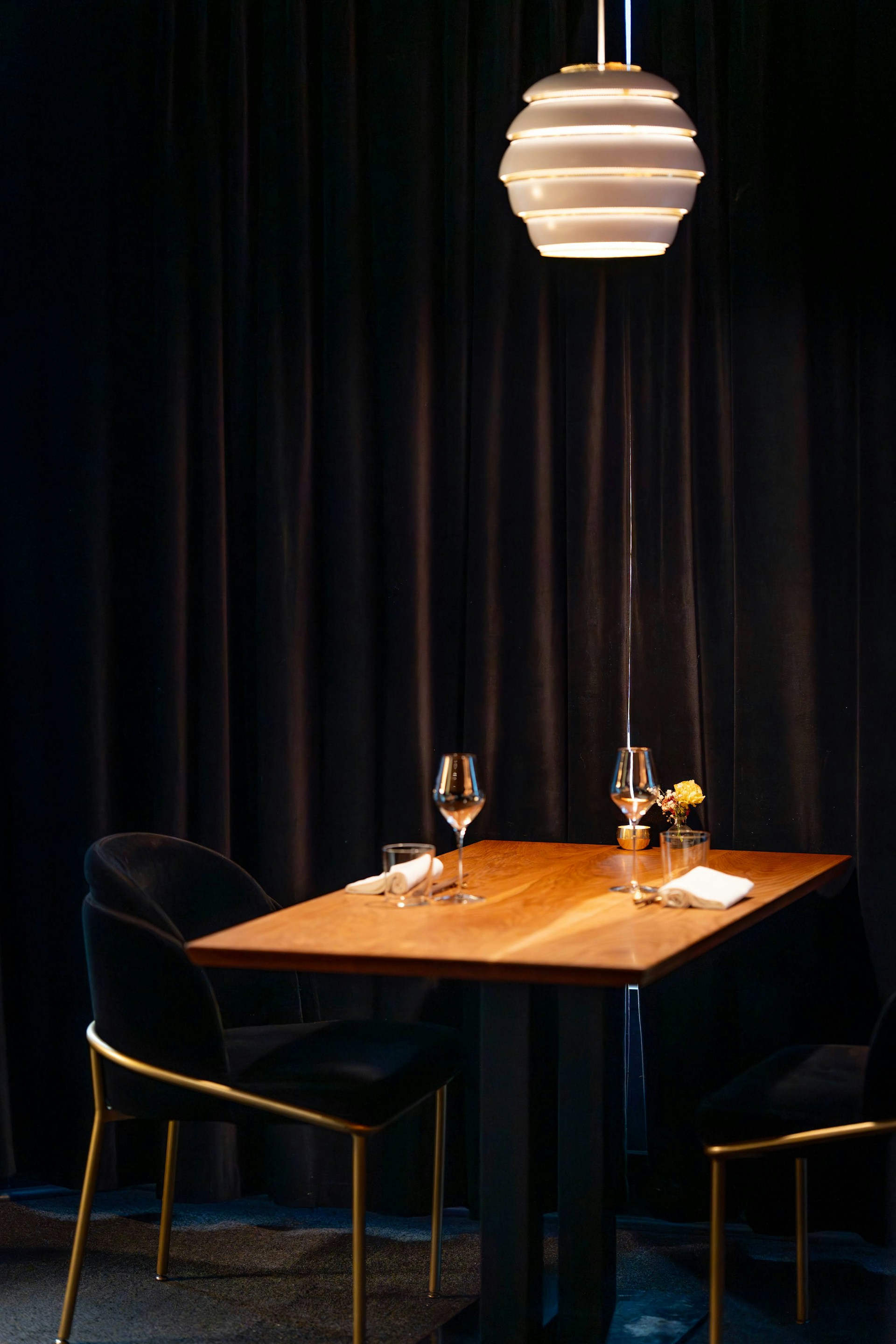 A table set for two with chairs and chairs