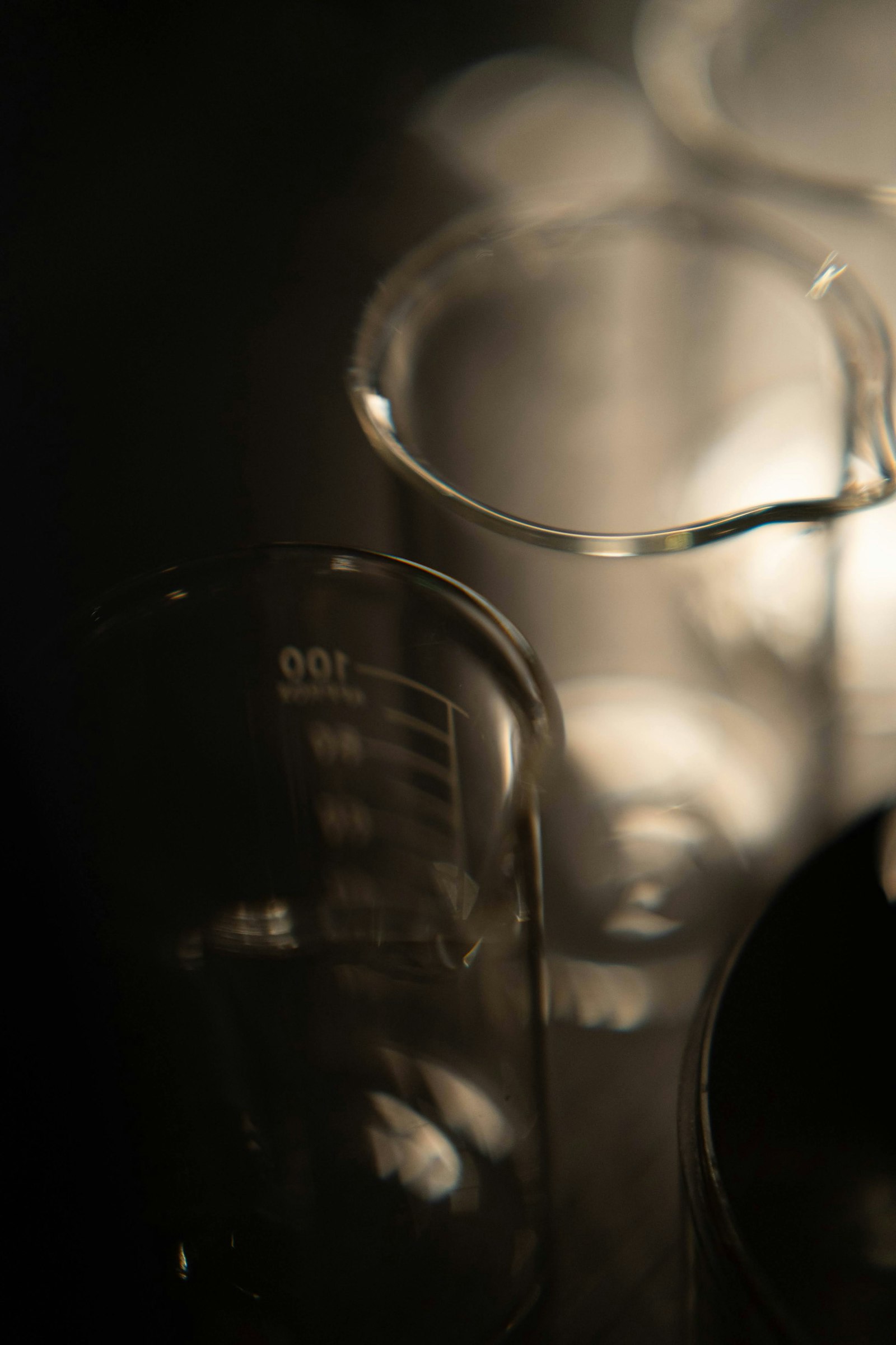 Glass laboratory beakers, representing the controlled manufacturing and clinical evidence that distinguish an approved medicine from an unverified vial