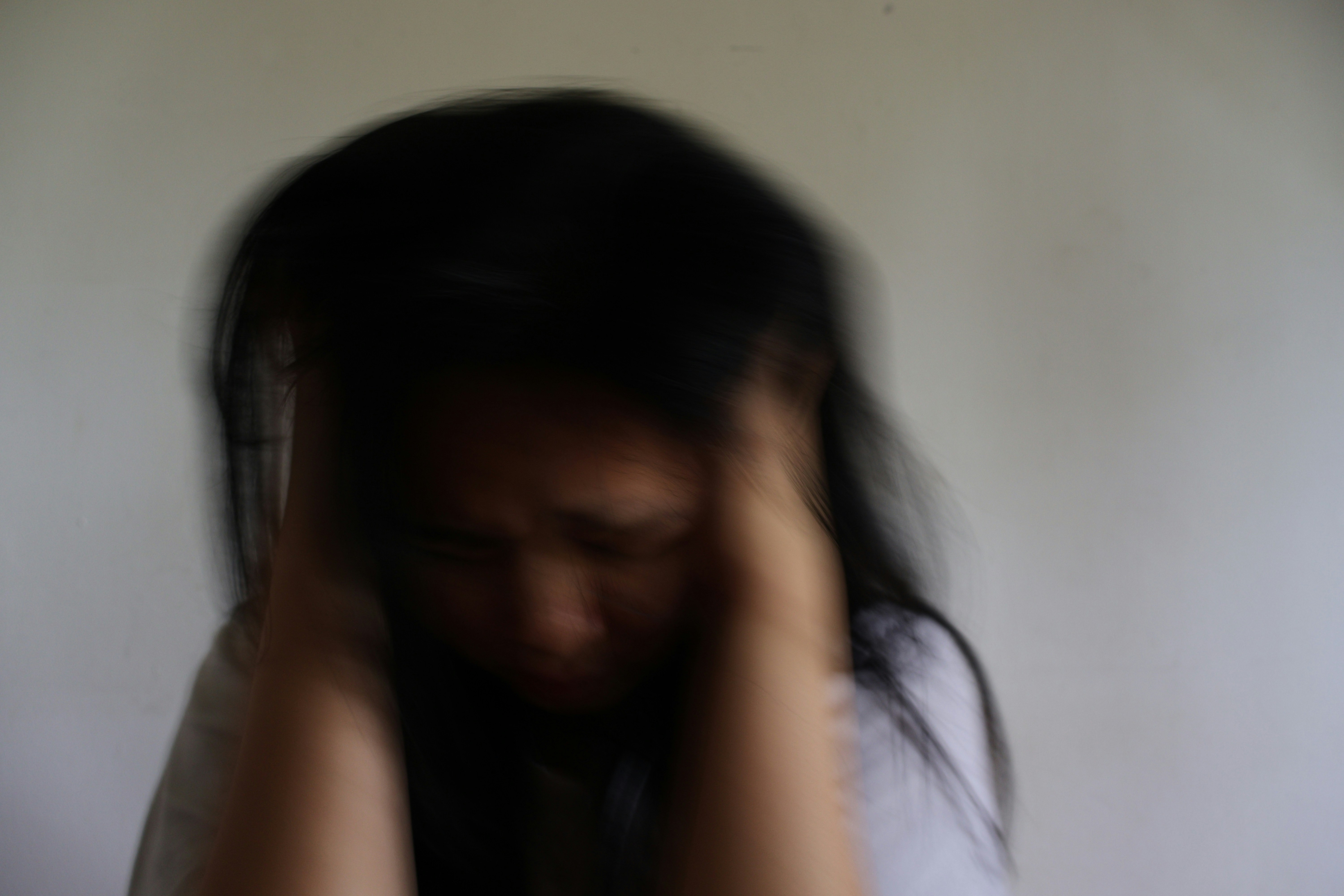 Woman holding her head in stress