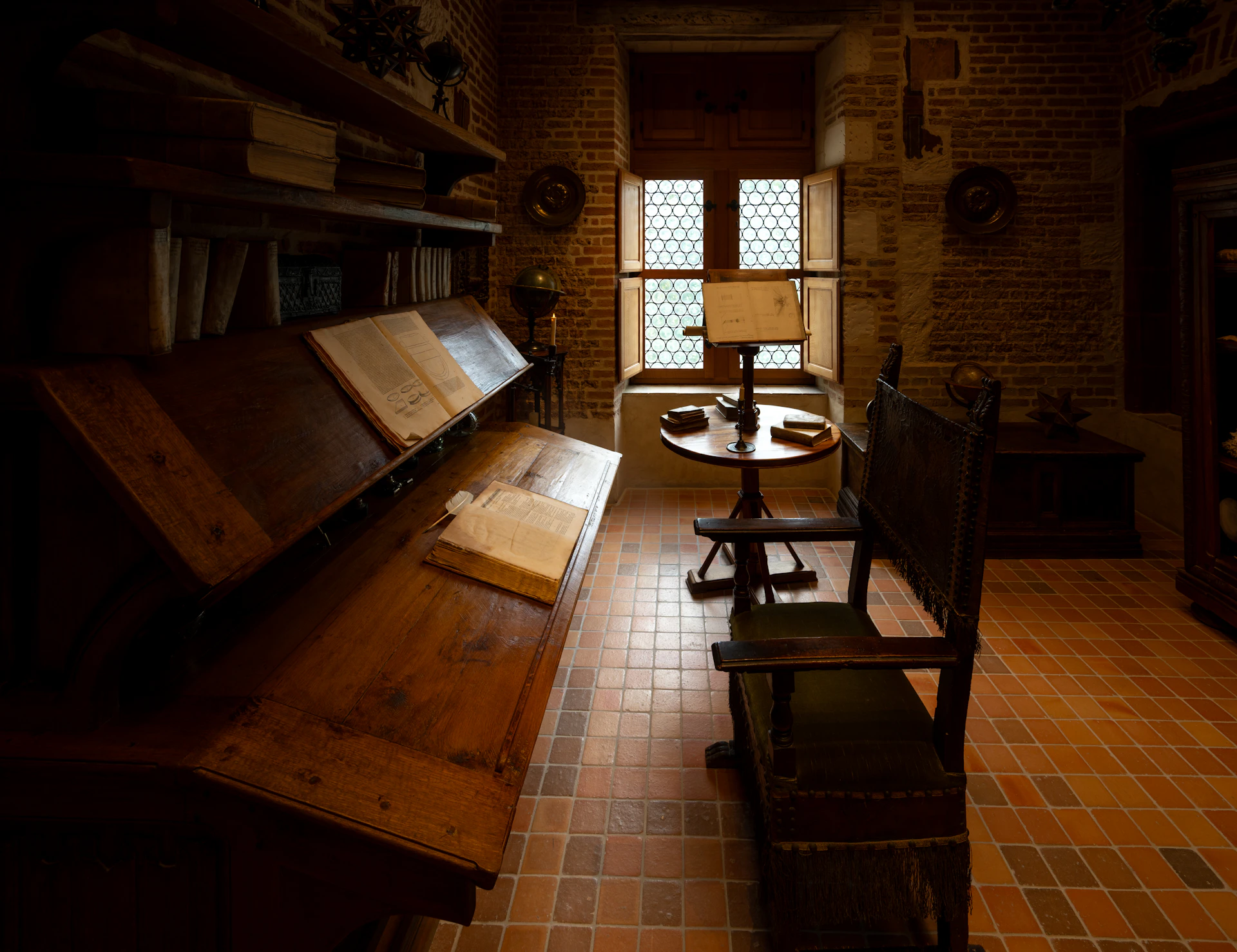 Old wooden desk with books and a lamp.