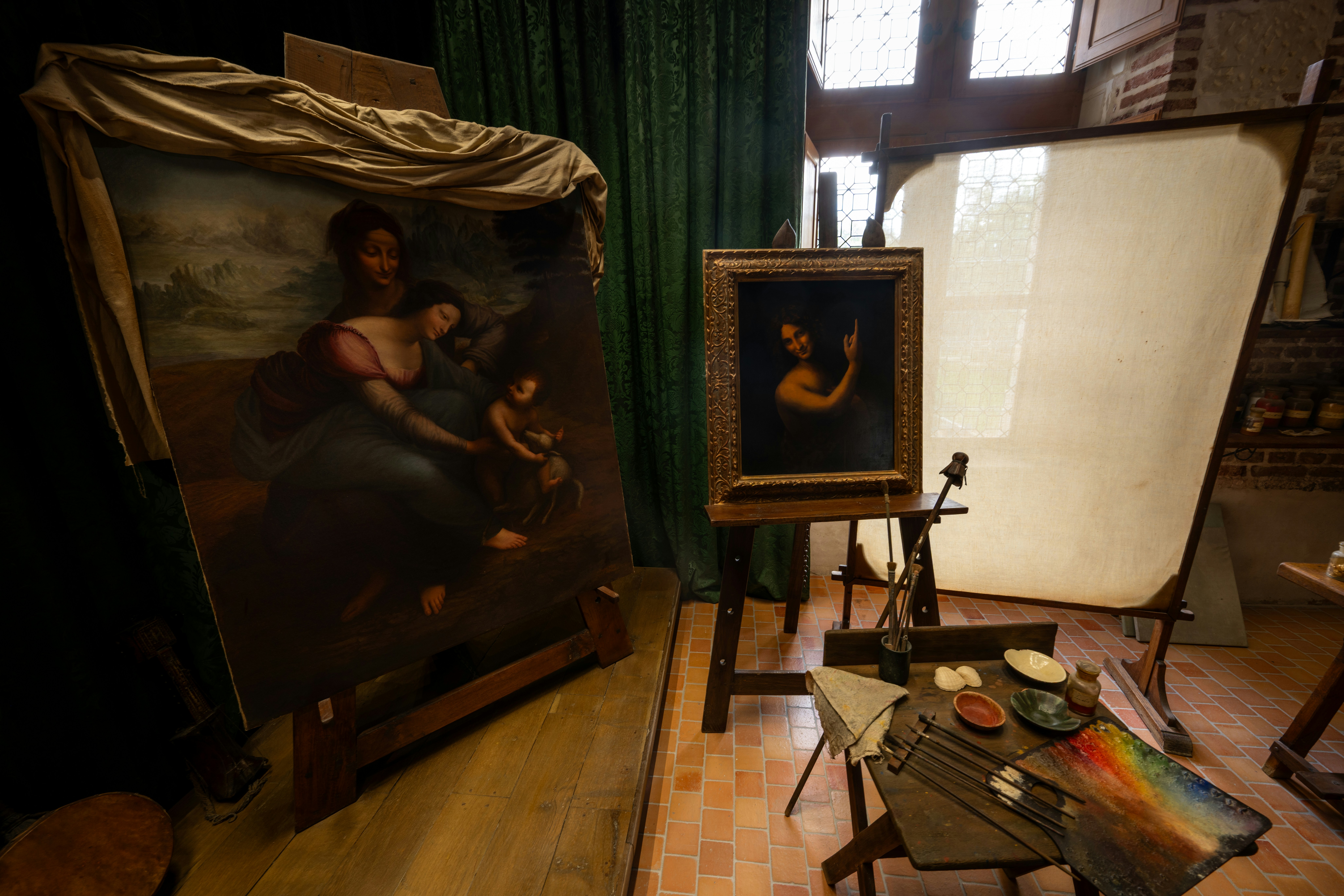 Two paintings displayed in an art studio setting