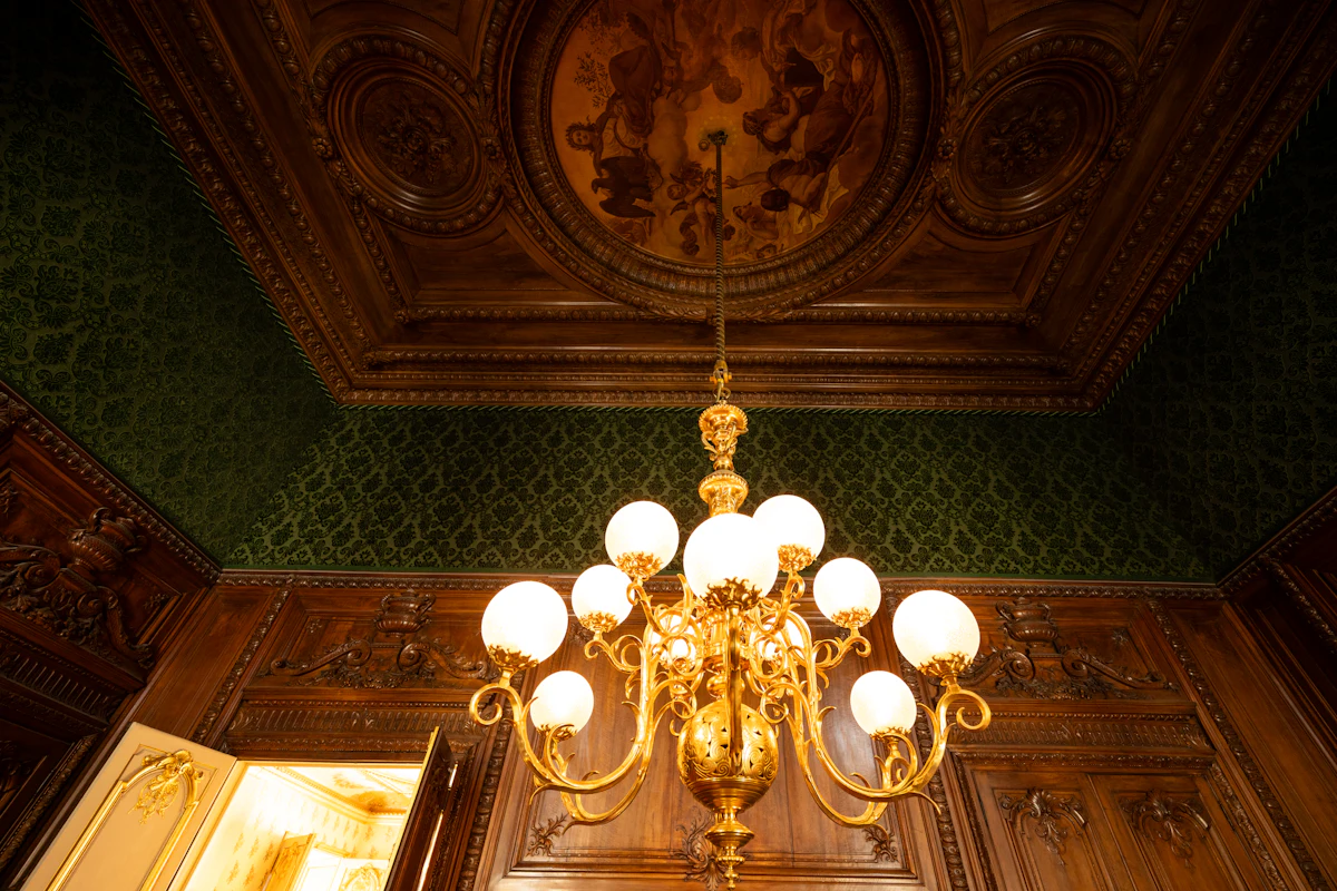 Painted ceiling and gilt chandelier. Illustrative editorial image, not a photograph of Casa Limón.
