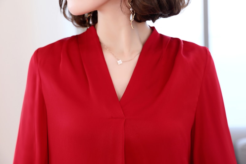 Elegant sugar mama in red blouse with jewelry