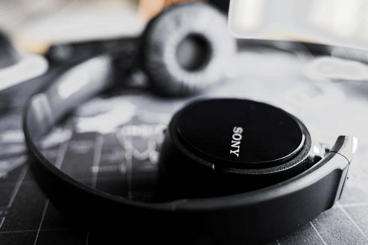Sony WH-1000XM7 headphones with a travel pouch packed for a trip