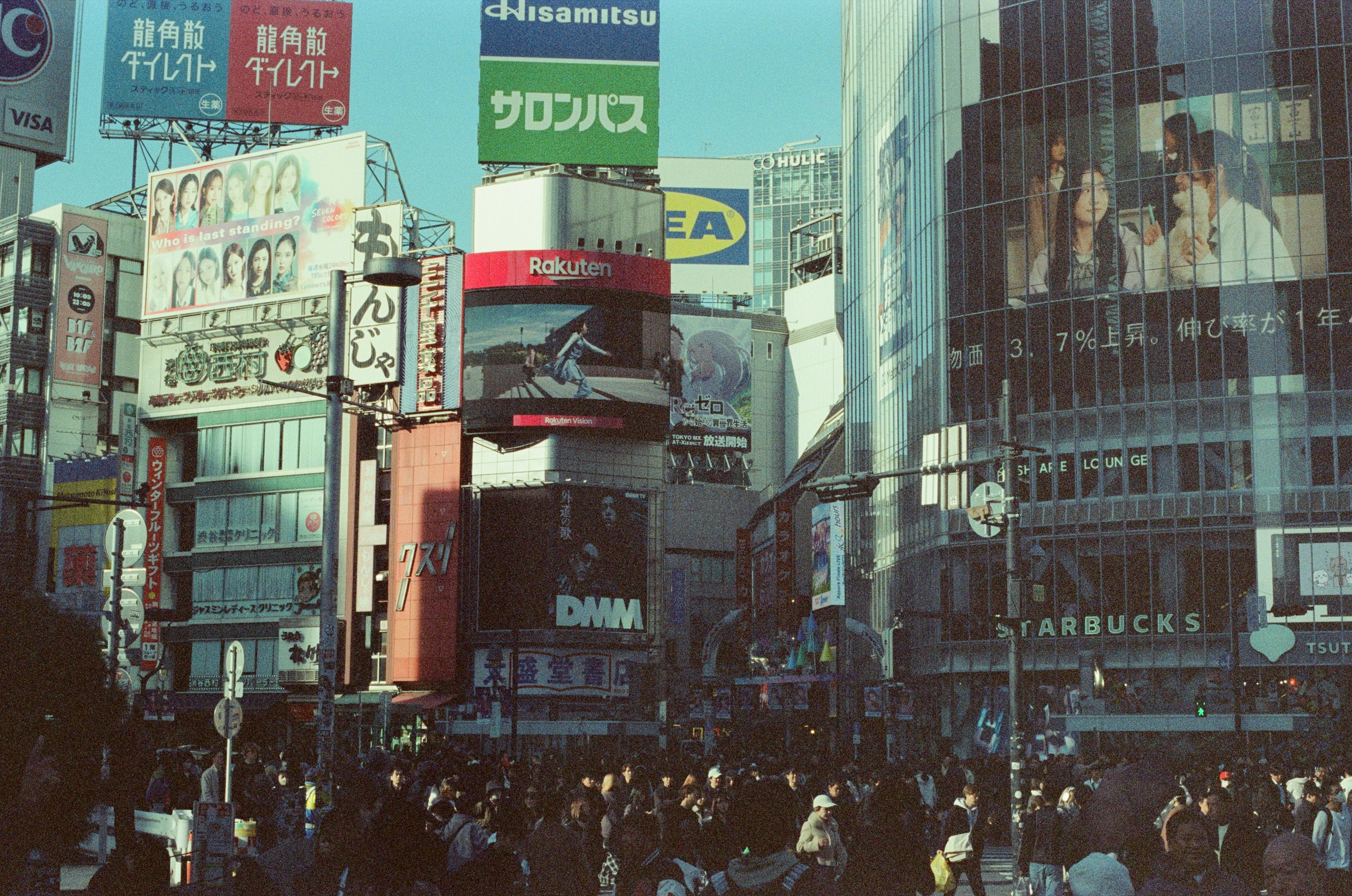 Busy city street with many billboards and people