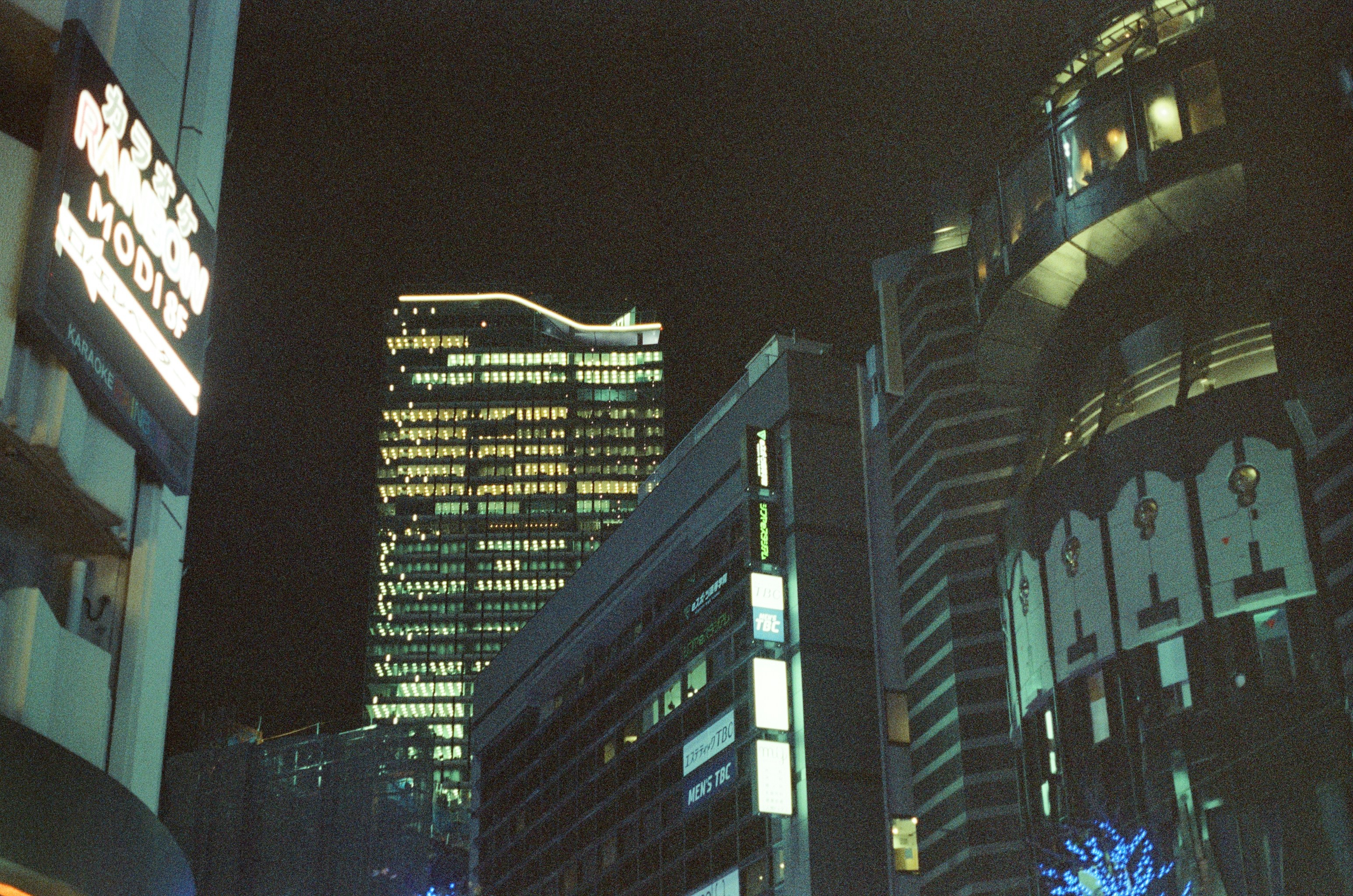 Illuminated skyscrapers in a city at night.