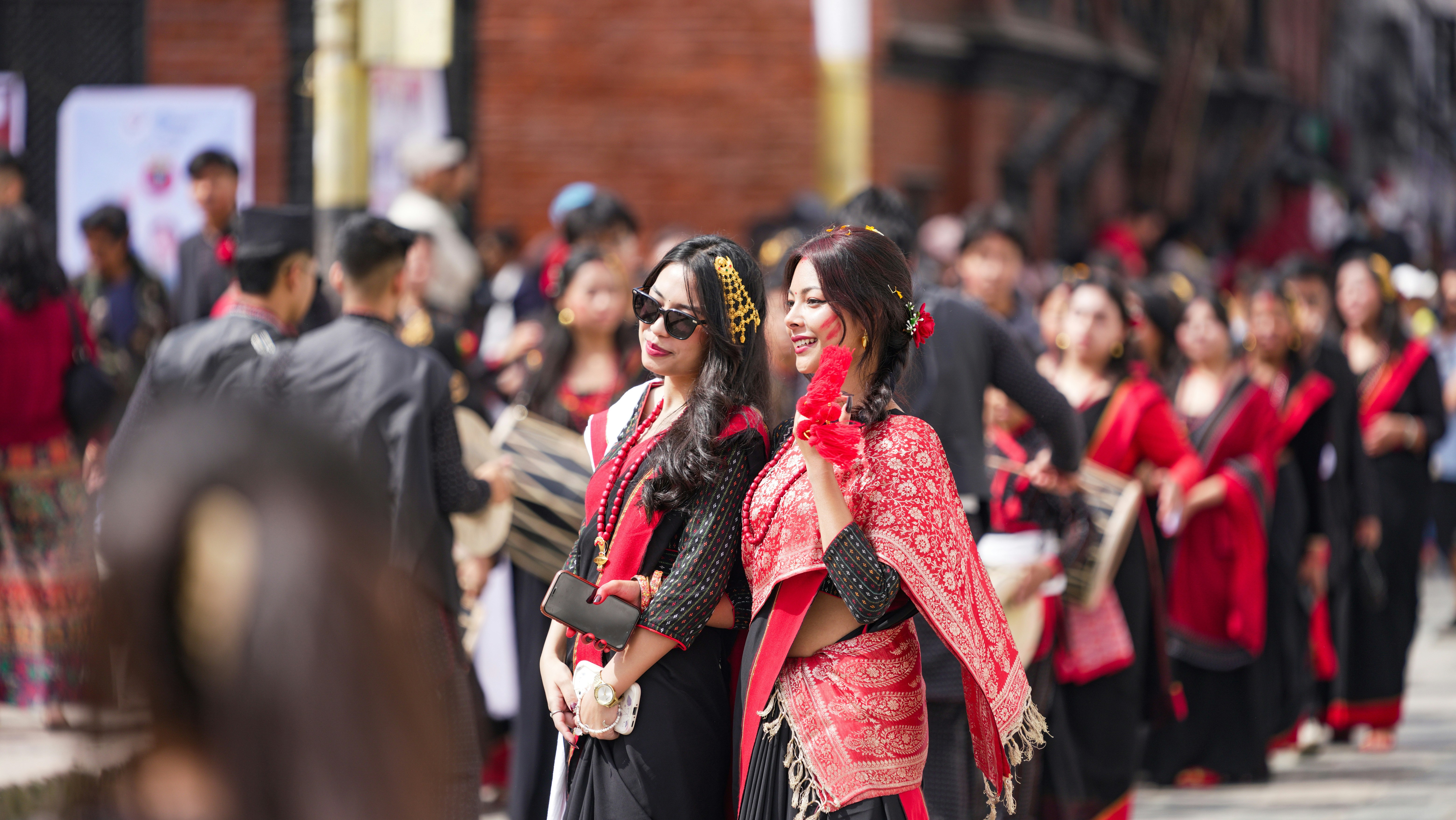 Women in traditional attire celebrating outdoors