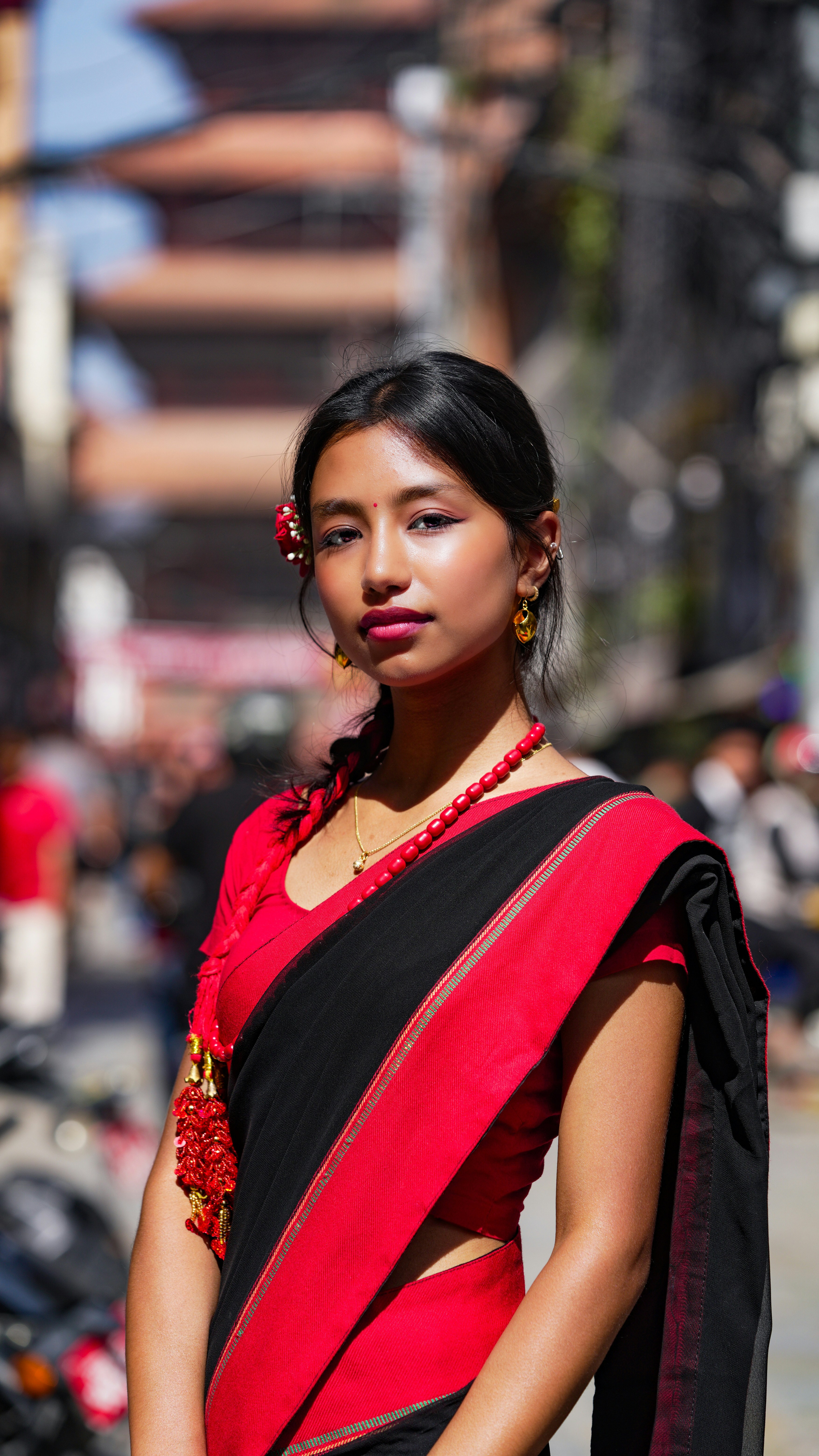 Young woman in traditional red and black sari