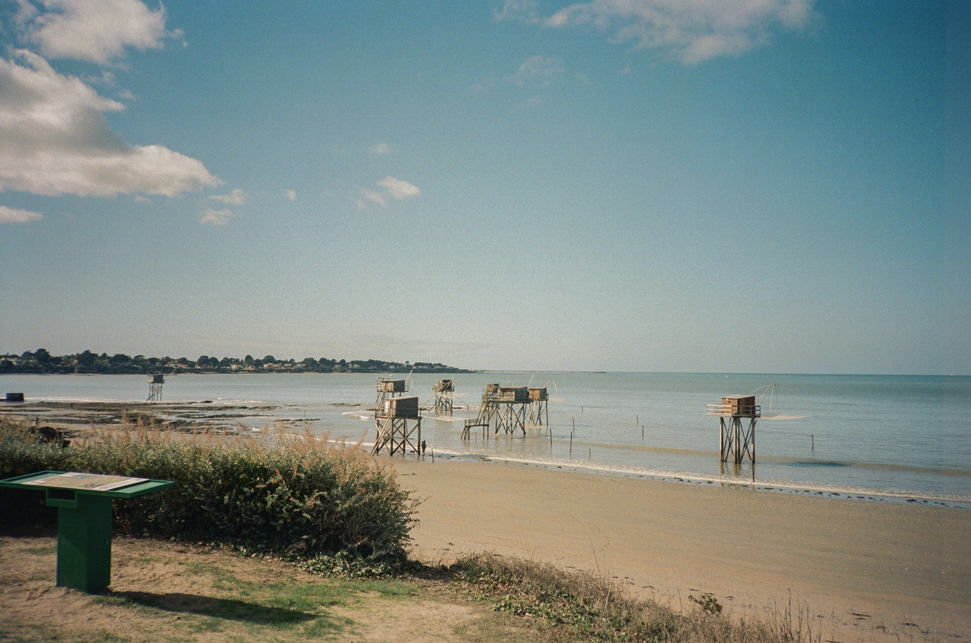 Beach huts on stilts at low tide