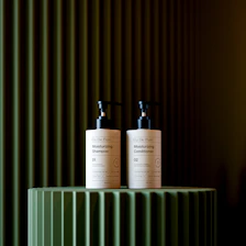 Two bottles of shampoo and conditioner on display.