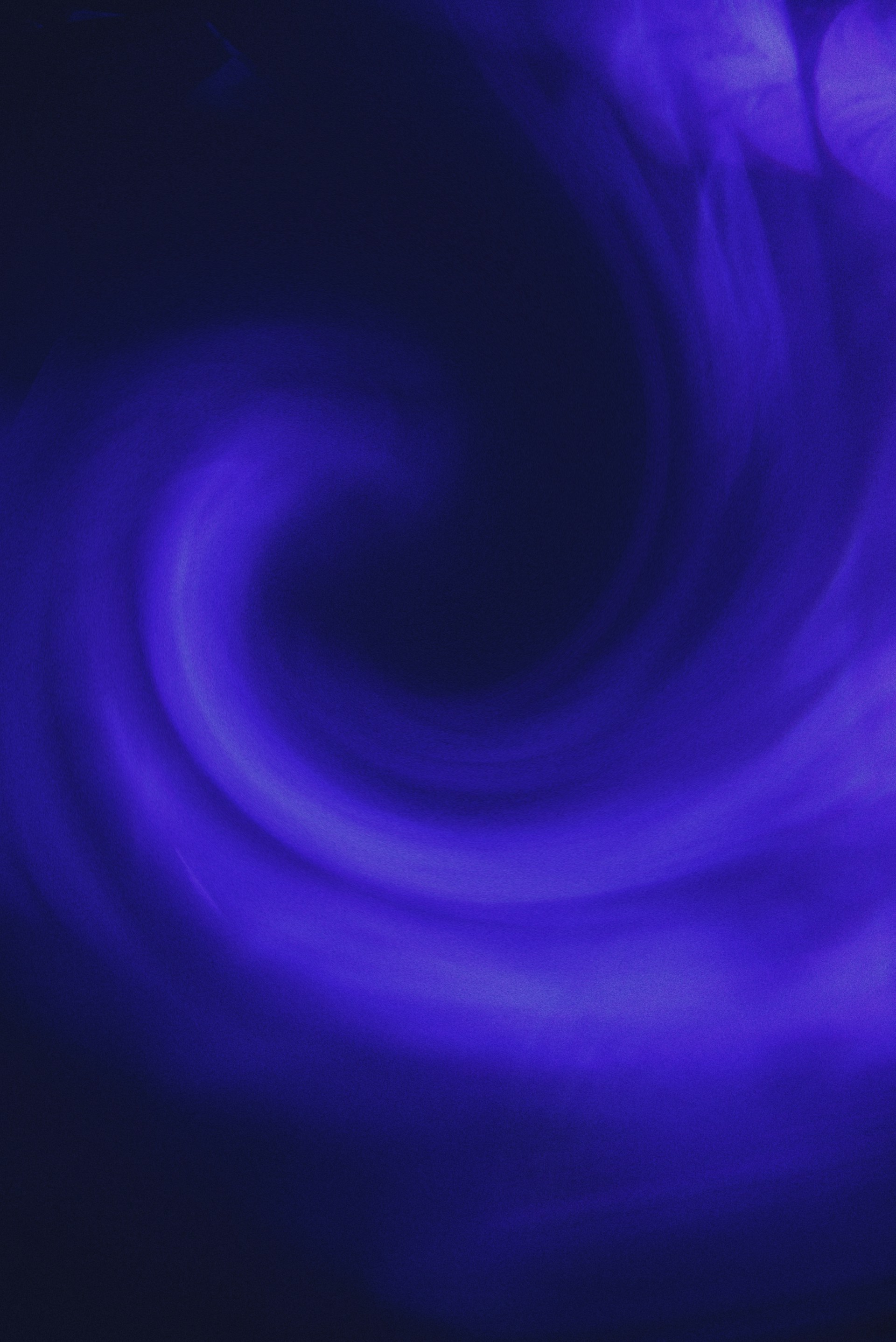 Abstract swirling deep blue and purple light