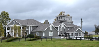 Large gray house with white trim and columns.