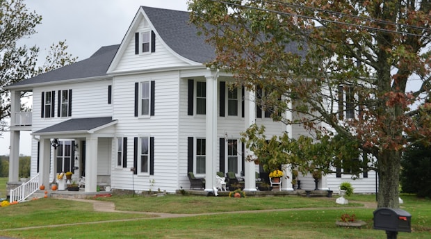 A large white colonial house with columns.