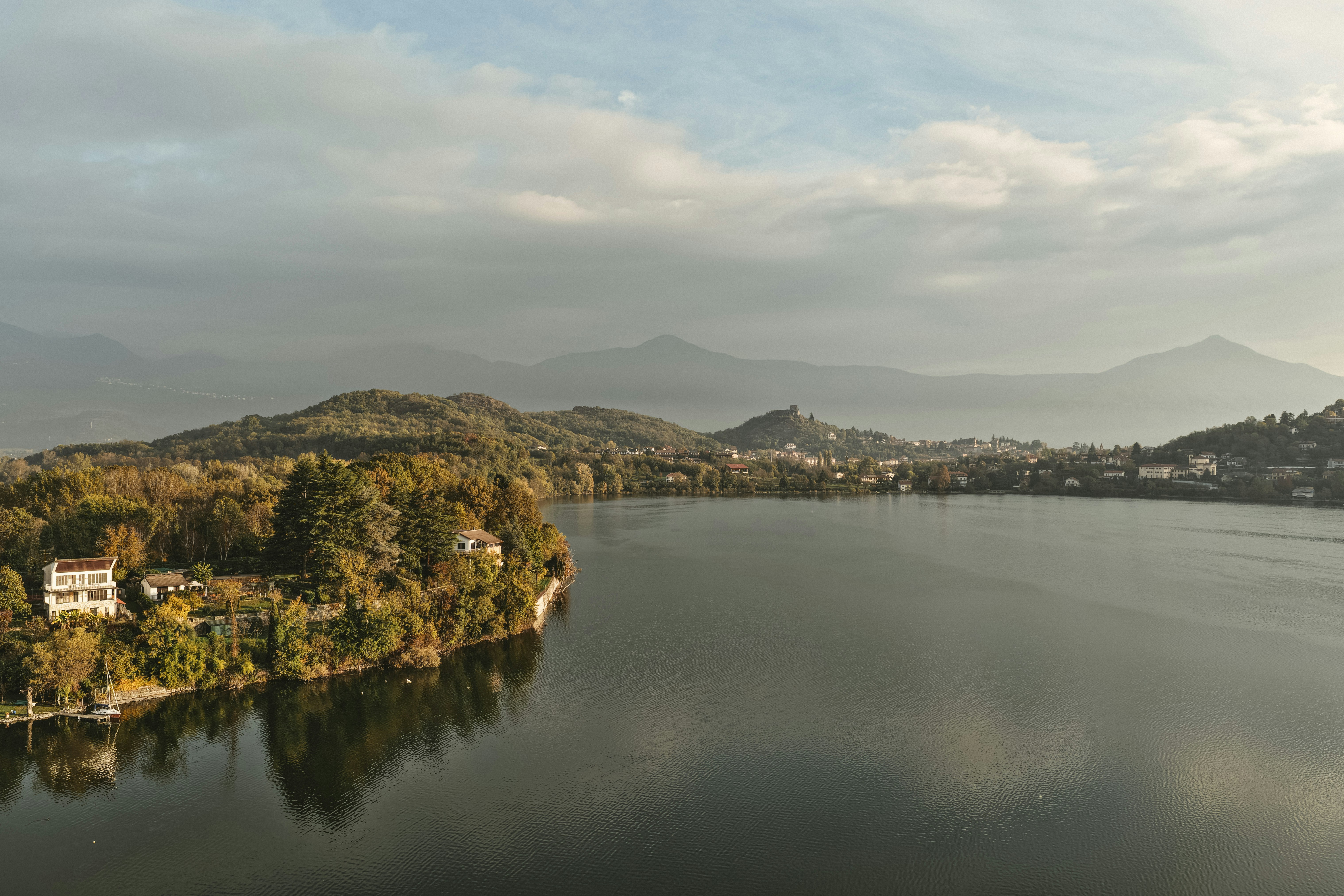 A serene lake surrounded by hills and autumn trees.