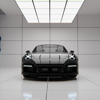 A sleek black sports car parked in a modern showroom.
