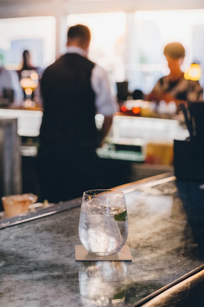 A refreshing drink sits on a bar counter.