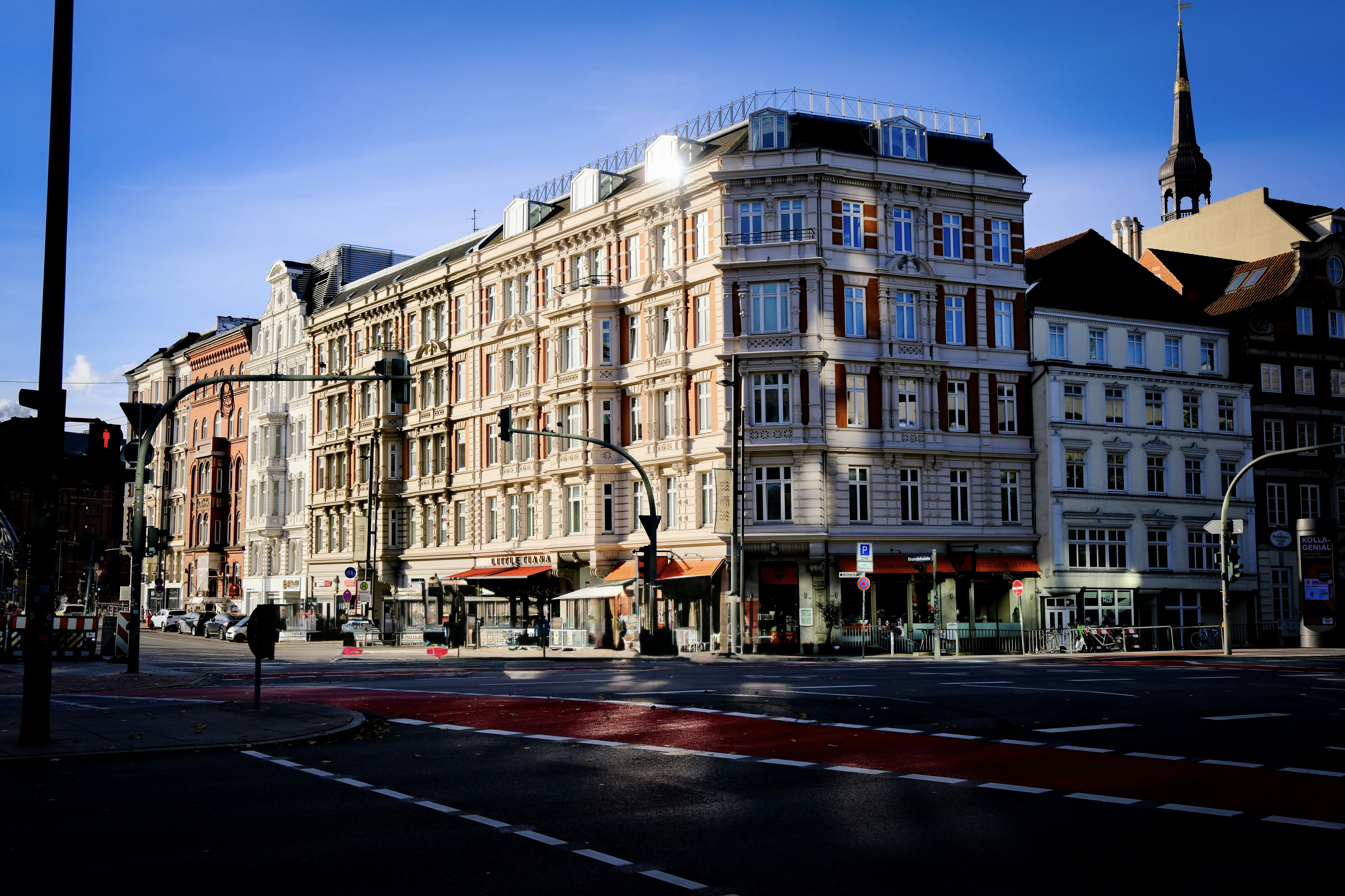 Buildings on a city street corner under blue sky