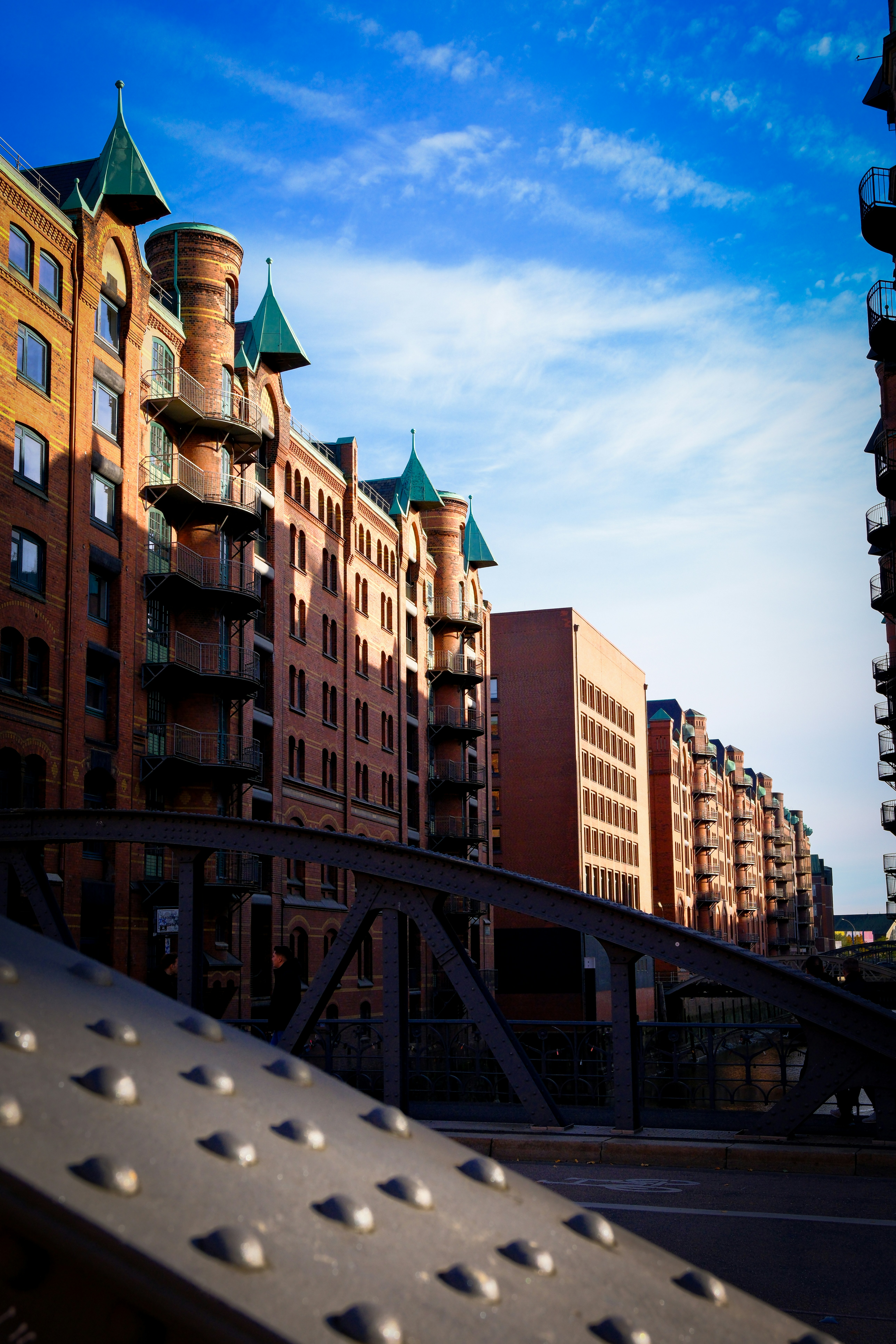Brick buildings with green roofs and a bridge.
