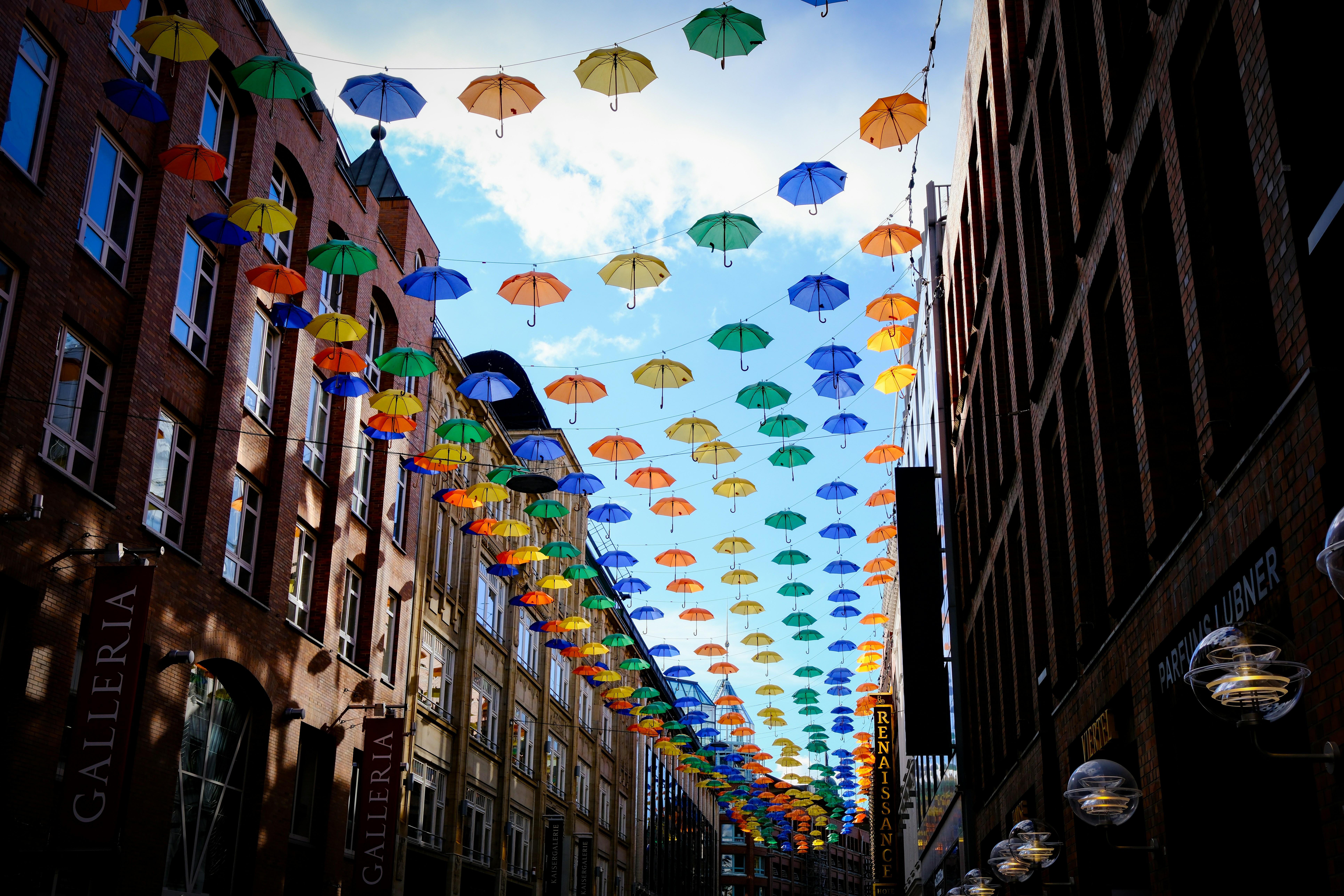 Colorful umbrellas over city street