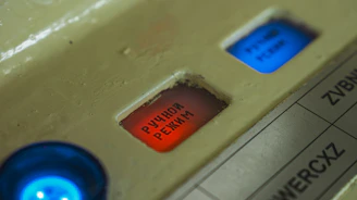 Red and blue buttons on a control panel.