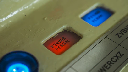 Red and blue buttons on a control panel.