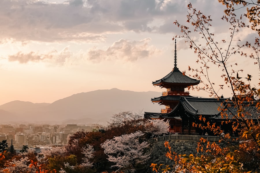 Cherry blossoms surrounding a traditional Japanese temple at sunset