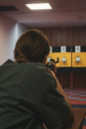 Woman aiming rifle at shooting range targets