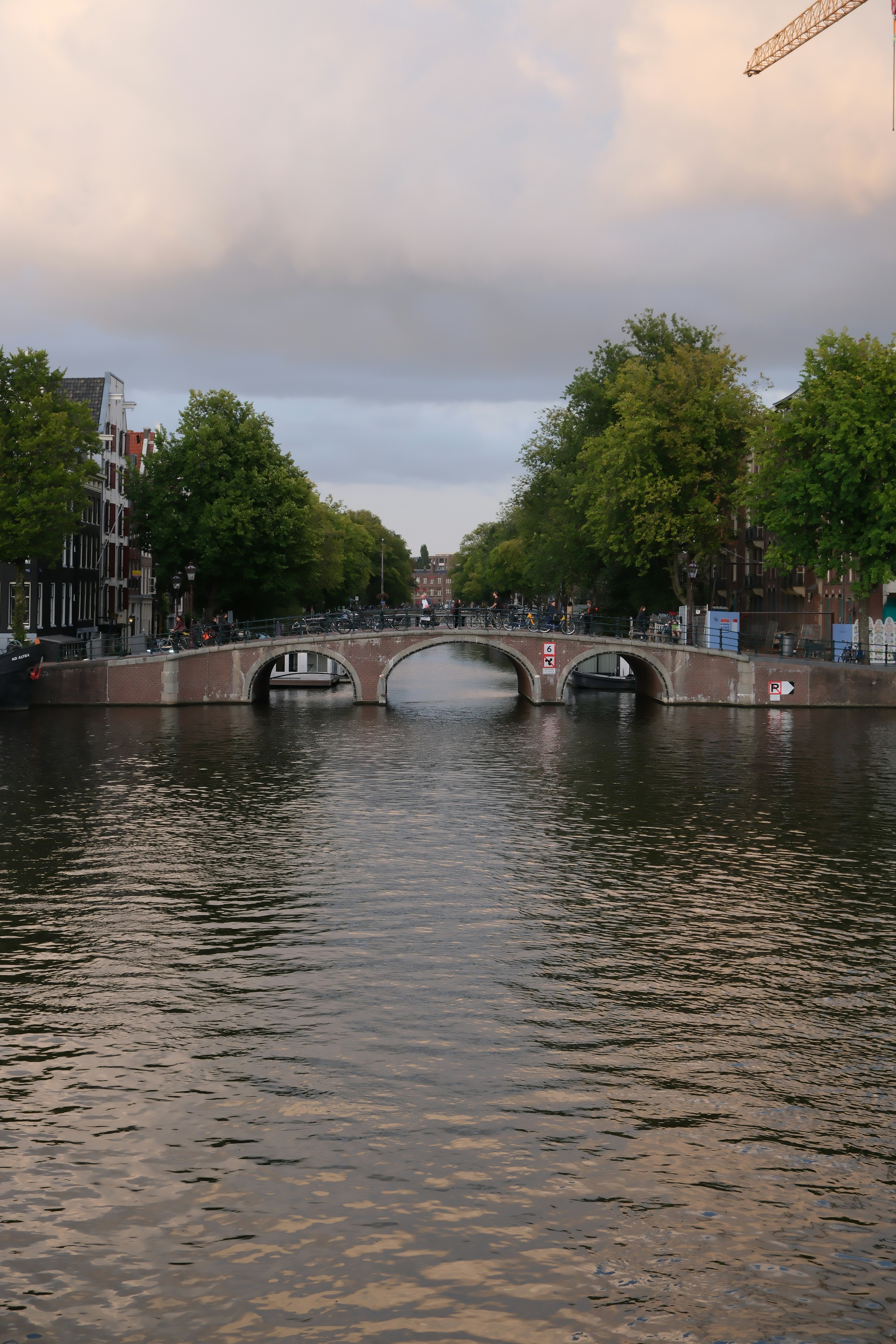 Canal bridge with trees and buildings in amsterdam - canal-bridge-with-trees-and-buildings-in-amsterdam-_RnDPeiJkb8