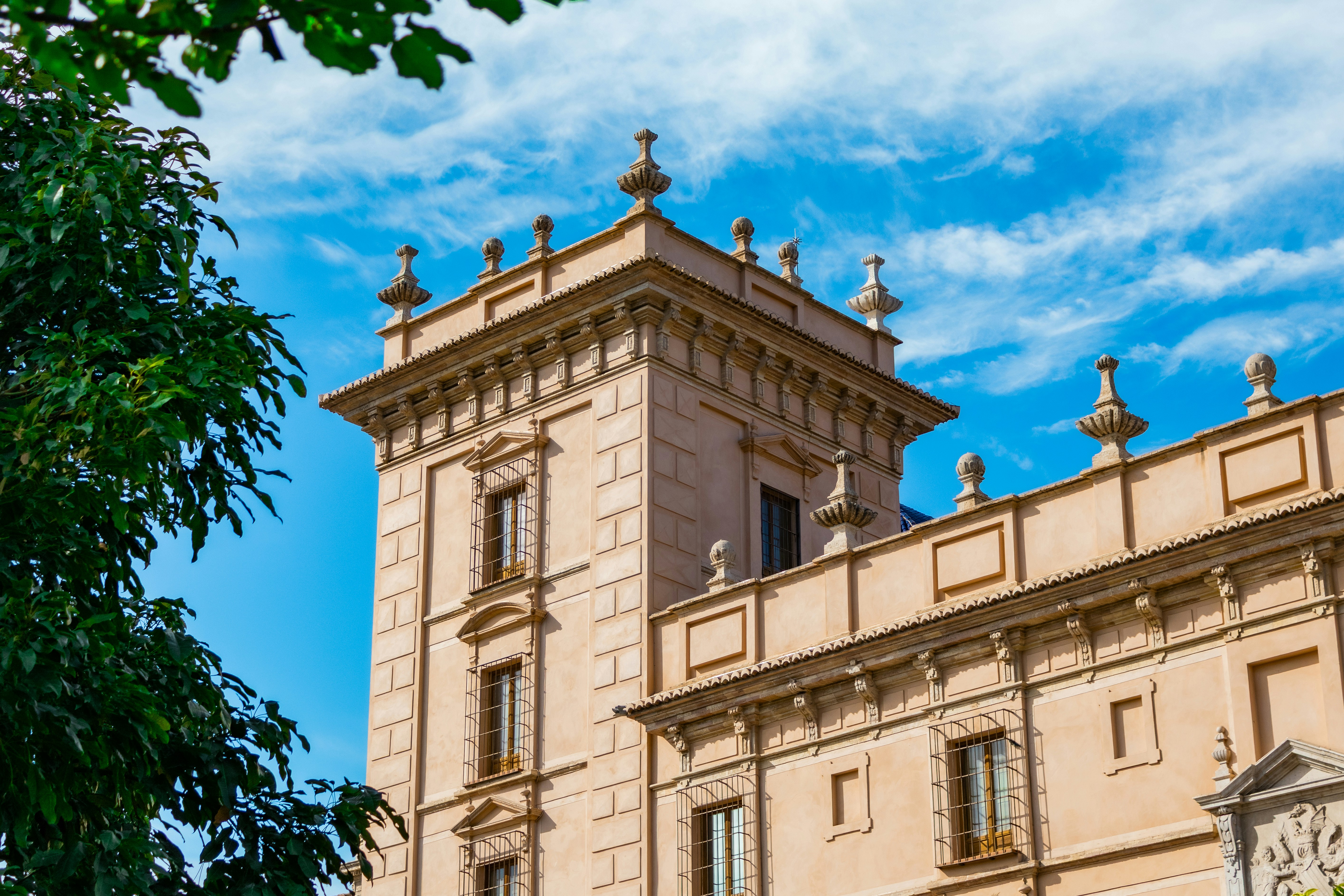 Ornate building with tower against blue sky