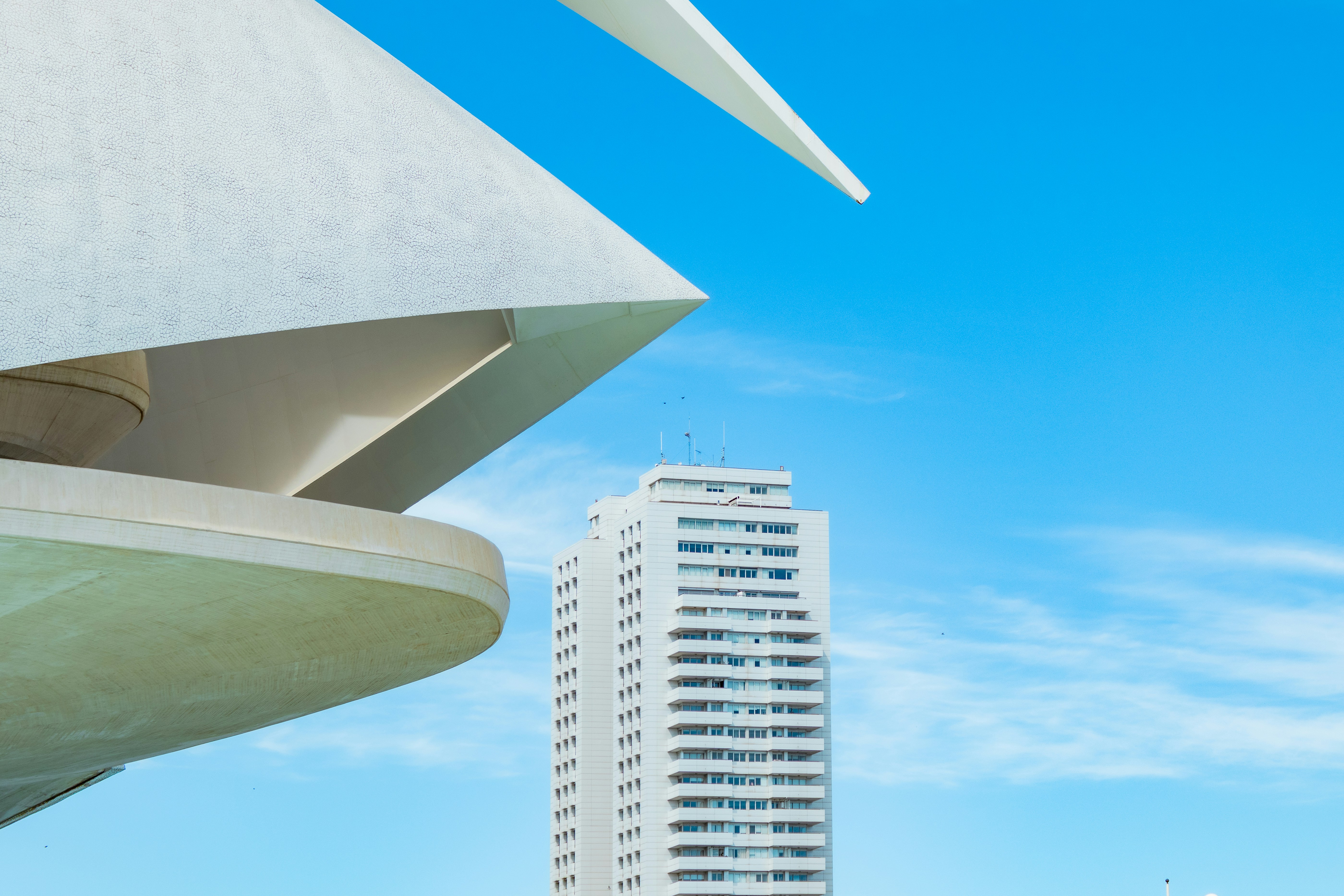 Modern white building against a bright blue sky