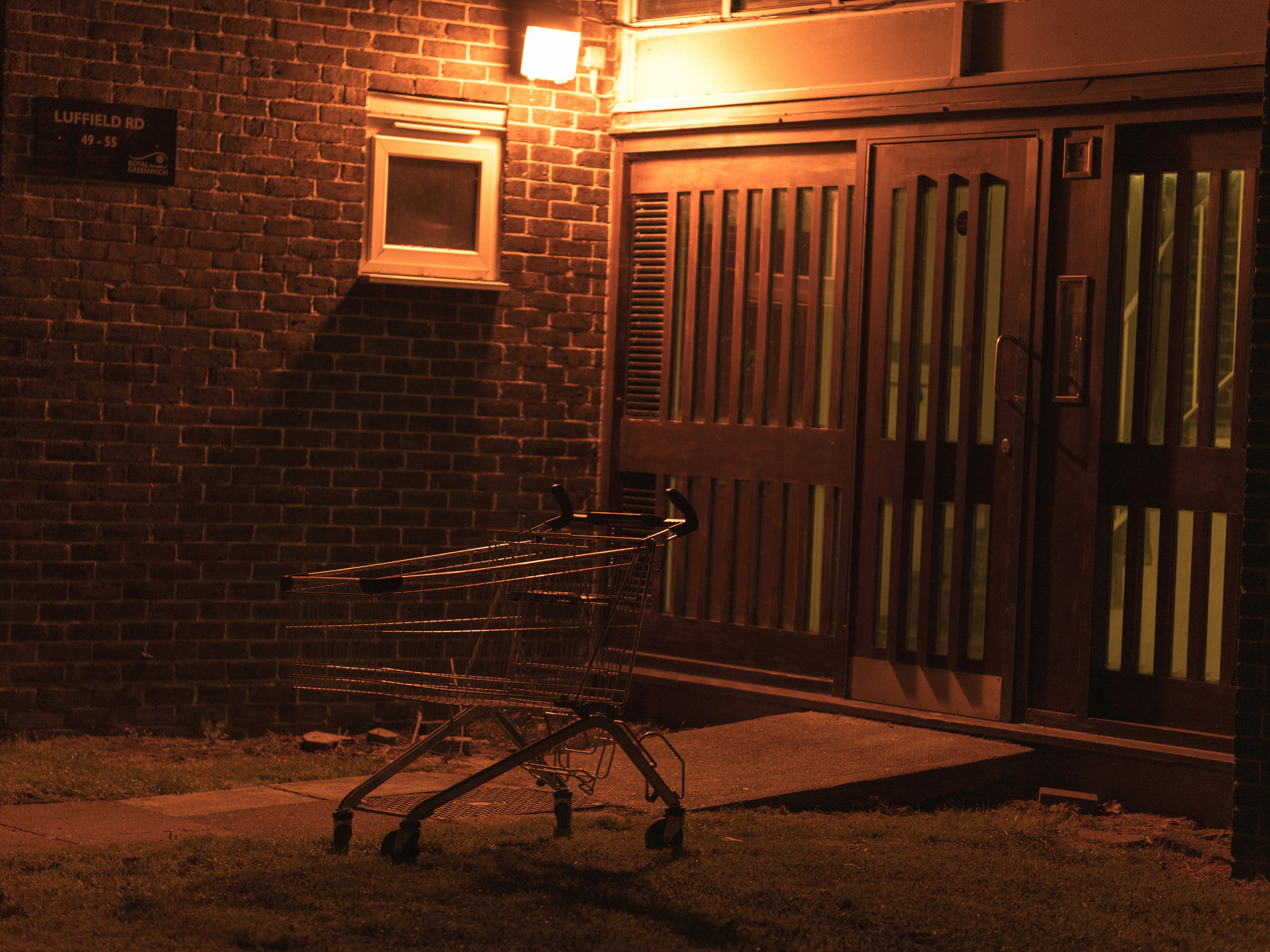 Shopping cart in front of a building at night
