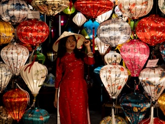 Vietnam’s National Dress: The Elegance of the Ao Dai Woman in red dress surrounded by lanterns