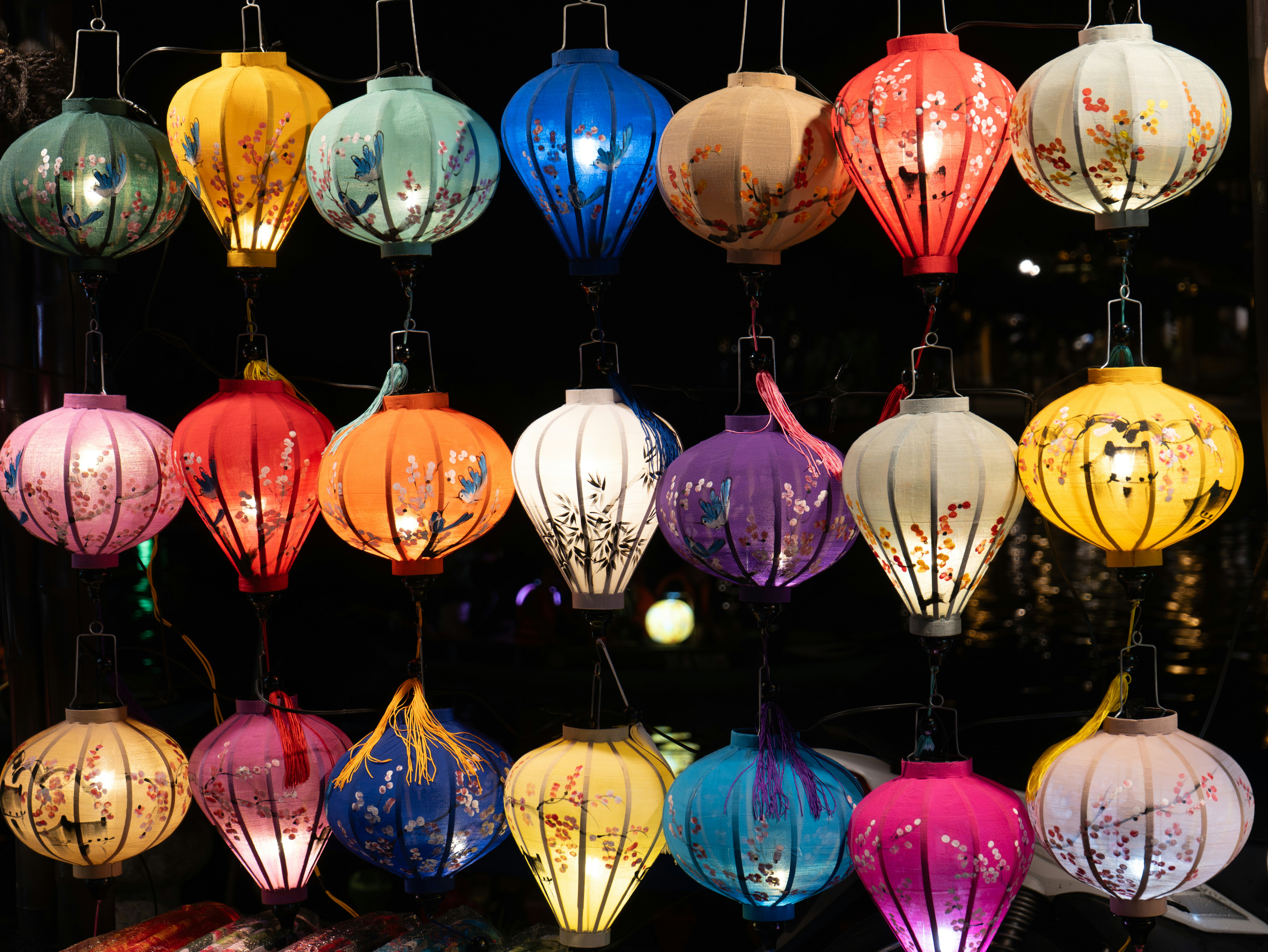 Colorful hanging lanterns illuminated at night